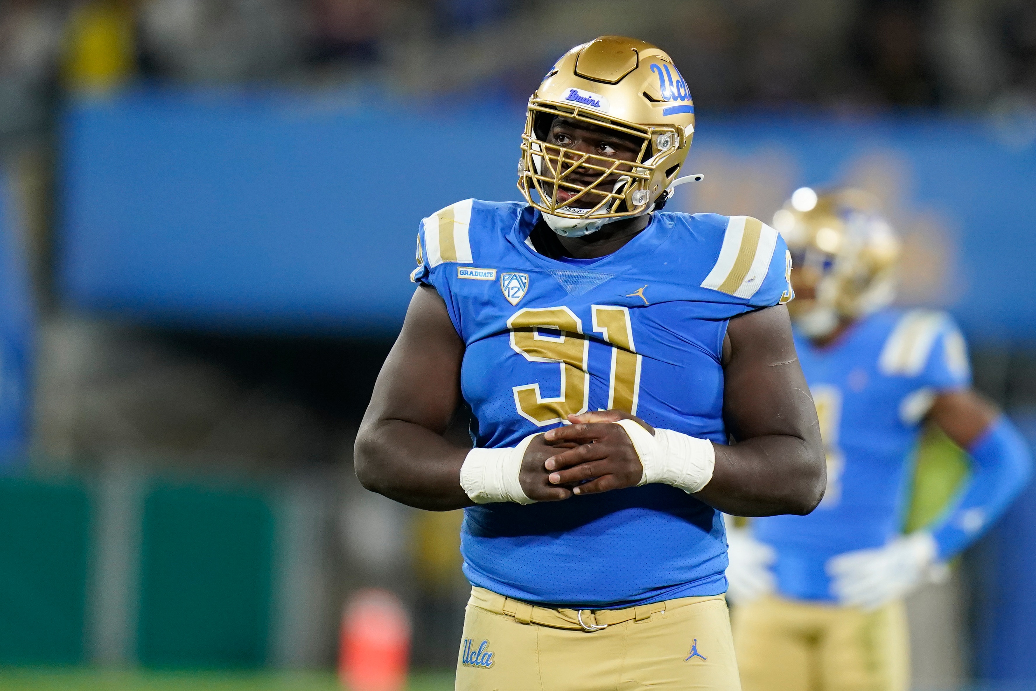 UCLA defensive lineman Otito Ogbonnia stands on field during the second half of an NCAA college football game against California Saturday, Nov. 27, 2021, in Pasadena, Calif. UCLA won 42-14. (AP Photo/Jae C. Hong)