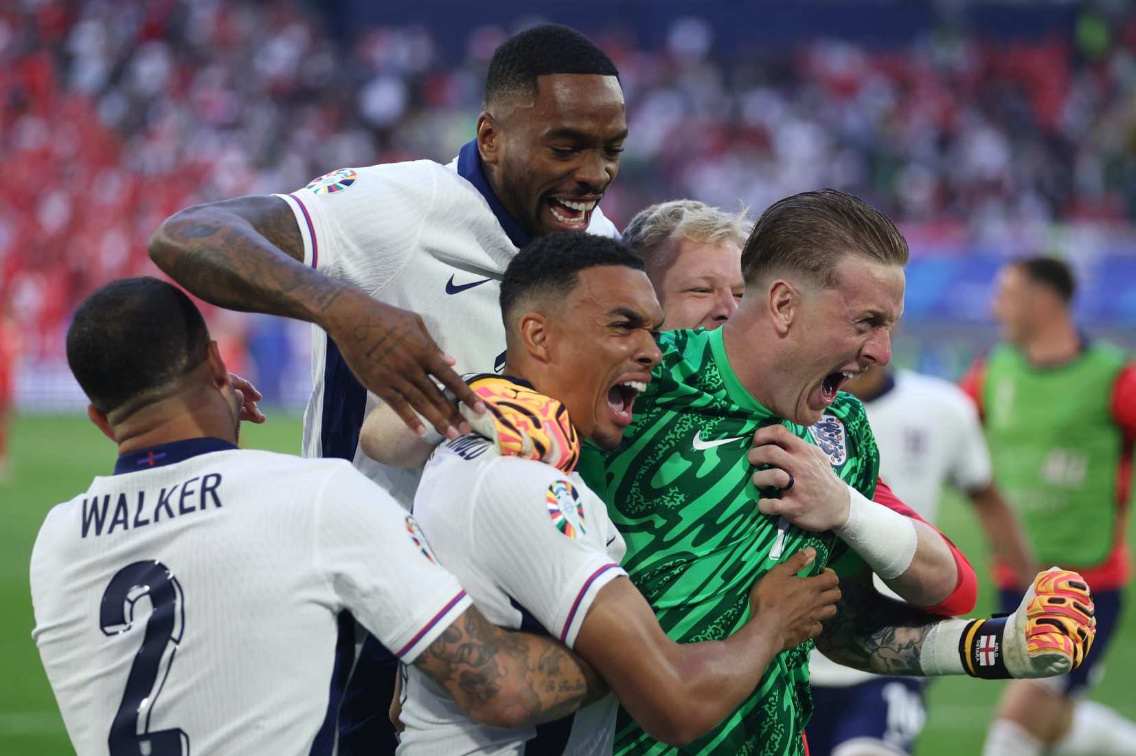 DUSSELDORF, GERMANY - JULY 06: Trent Alexander-Arnold of England celebrates scoring the team's fifth and winning penalty in the penalty shoot out with teammates Kyle Walker, Ivan Toney and Jordan Pickford during the UEFA EURO 2024 quarter-final match between England and Switzerland at Düsseldorf Arena on July 06, 2024 in Dusseldorf, Germany. (Photo by Dean Mouhtaropoulos/Getty Images)