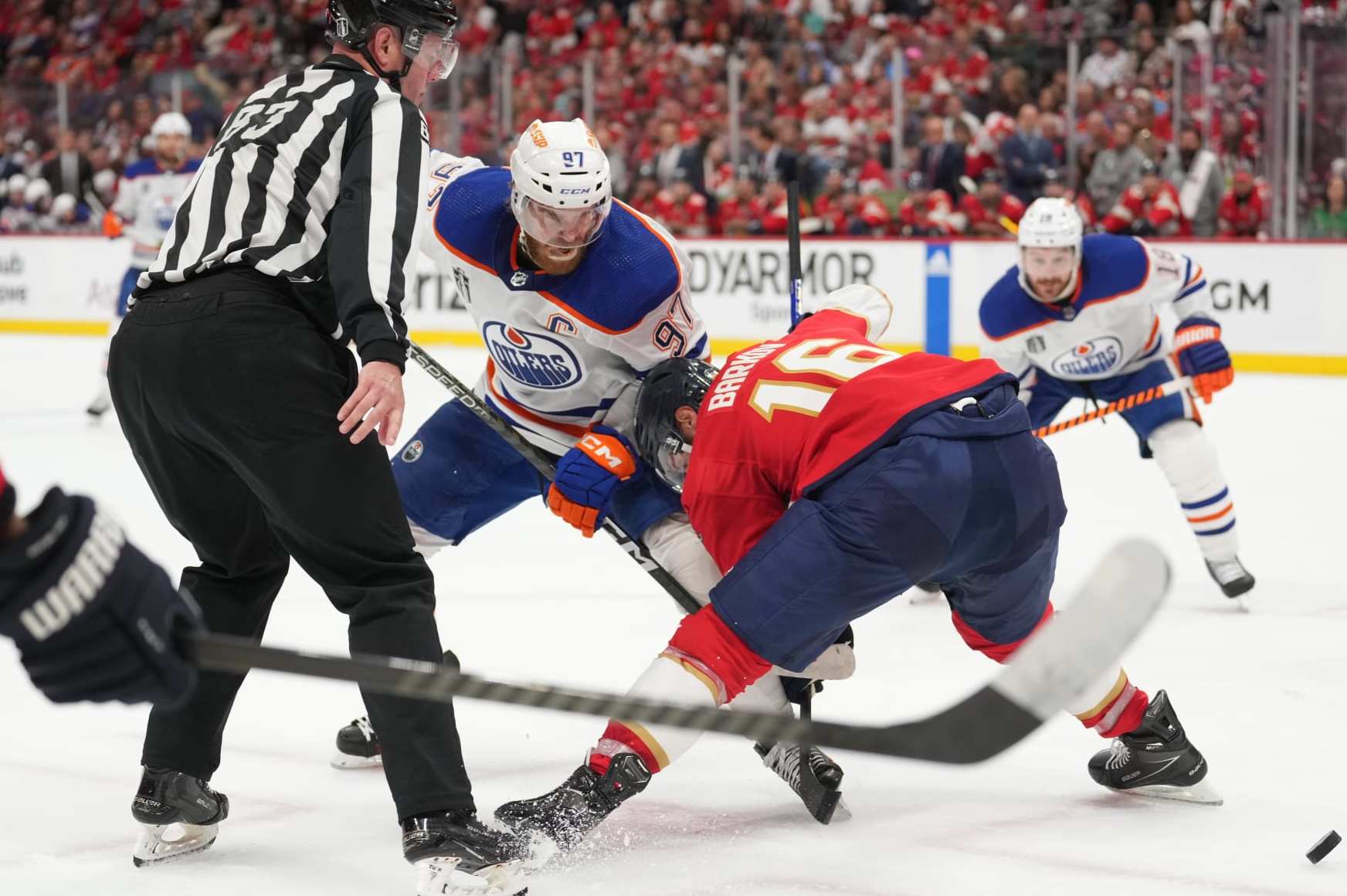 SUNRISE, FL - JUNE 08: Florida Panthers center Aleksander Barkov (16) beats Edmonton Oilers center Connor McDavid (97) during a face-off in the first periodduring game one of the Stanley Cup Finals between the Edmonton Oilers and the Florida Panthers on Saturday, June 8, 2024 at Amerant Bank Area in Sunrise, Fla. (Photo by Peter Joneleit/Icon Sportswire via Getty Images)