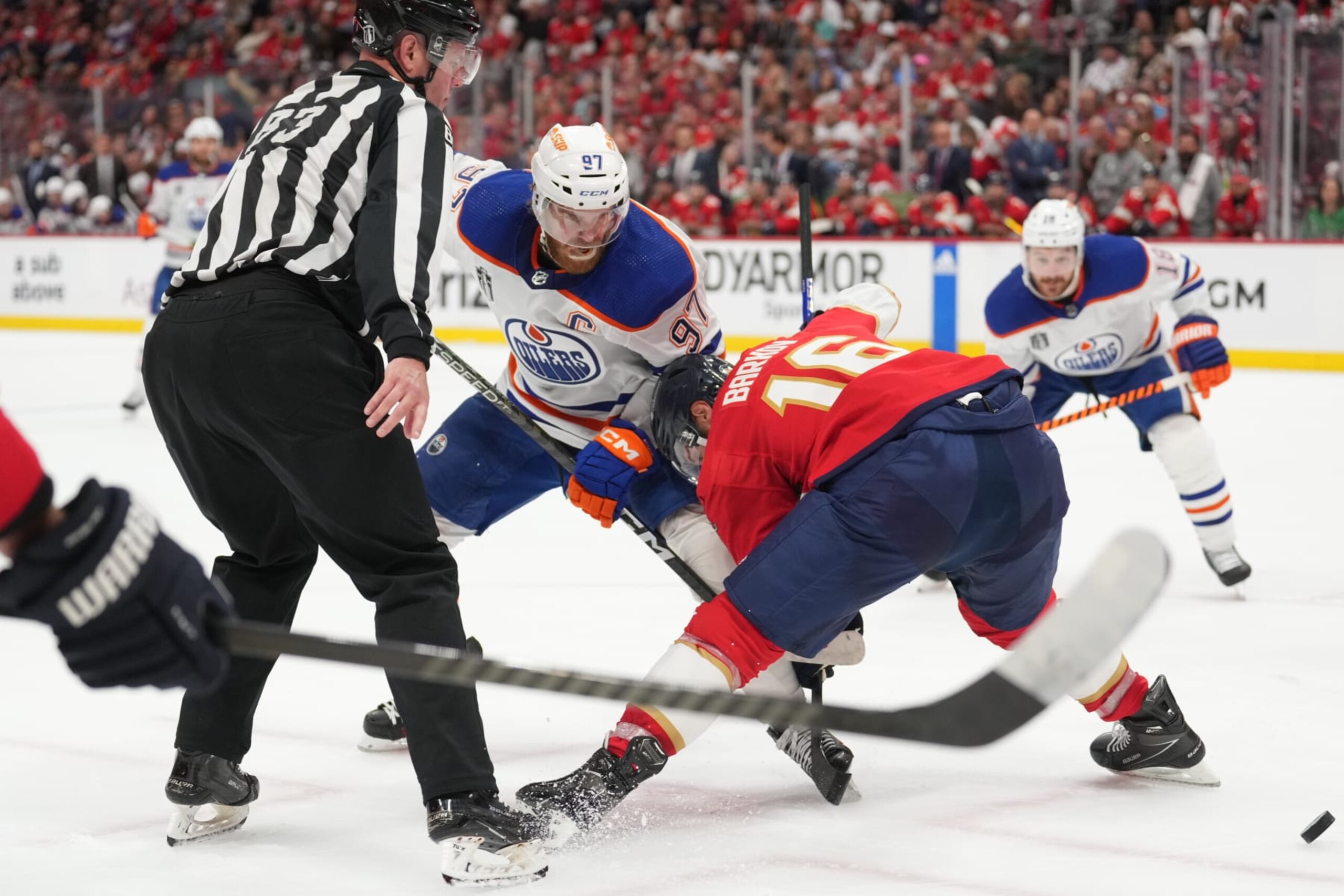 SUNRISE, FL - JUNE 08: Florida Panthers center Aleksander Barkov (16) beats Edmonton Oilers center Connor McDavid (97) during a face-off in the first periodduring game one of the Stanley Cup Finals between the Edmonton Oilers and the Florida Panthers on Saturday, June 8, 2024 at Amerant Bank Area in Sunrise, Fla. (Photo by Peter Joneleit/Icon Sportswire via Getty Images)