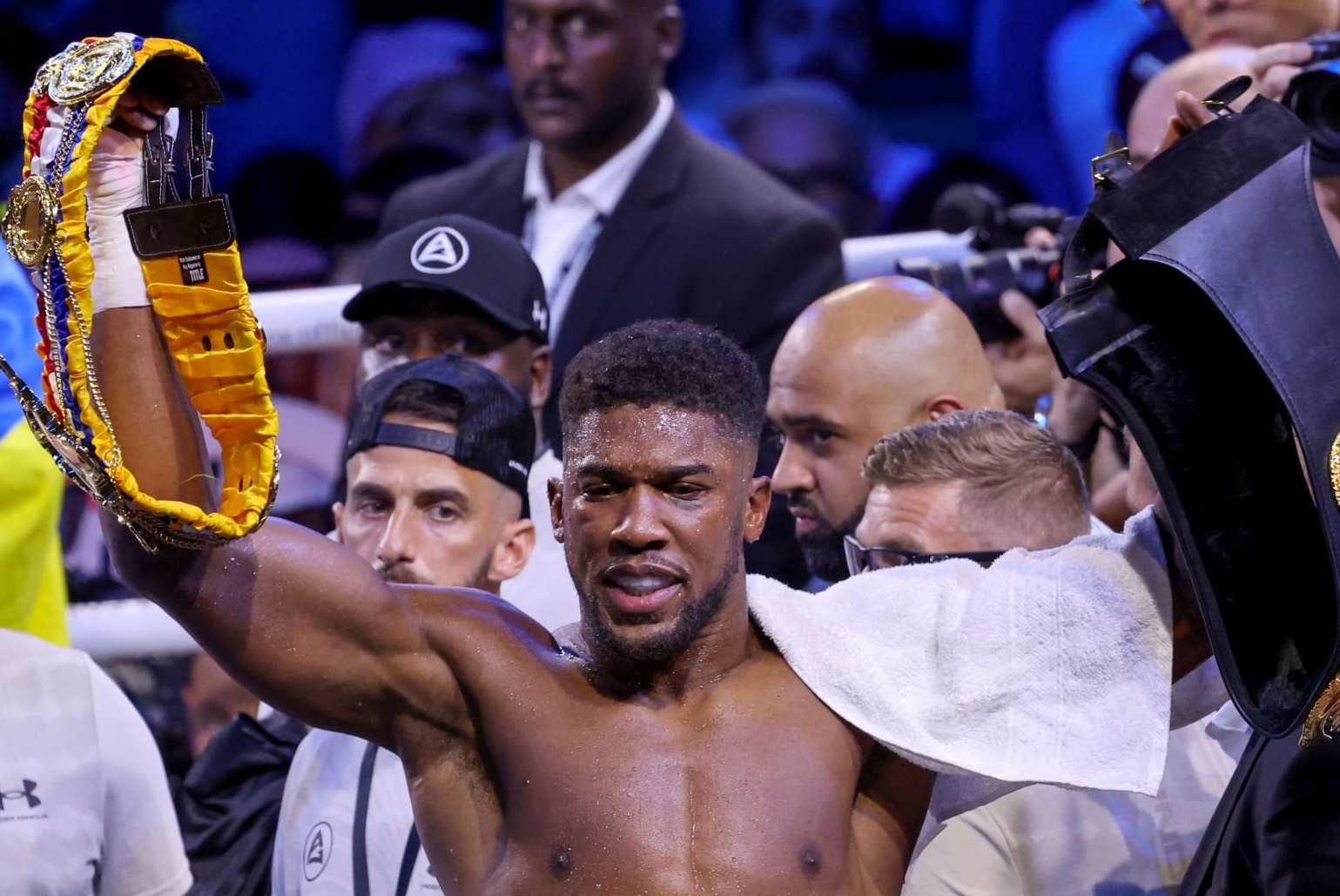 Britain's Anthony Joshua (L) reacts after losing to Ukraine's Oleksandr Usyk (R) after the heavyweight boxing rematch for the WBA, WBO, IBO and IBF titles at the King Abdullah Sports City Arena in the Saudi Red Sea city of Jeddah, on August 20, 2022. - Usyk won his rematch against Anthony Joshua by split decision to retain his world heavyweight titles in just his fourth fight in the division in Saudi Arabia late tonight. (Photo by Giuseppe CACACE / AFP) (Photo by GIUSEPPE CACACE/AFP via Getty Images)