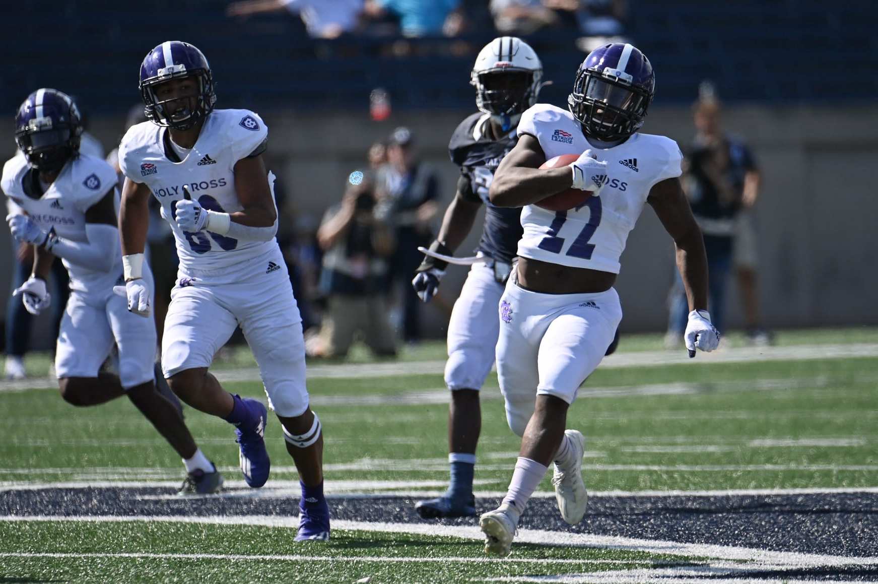 NEW HAVEN, CT - SEPTEMBER 18: Holy Cross Crusaders running back Jonathan Abrams (22) finds a gap and rushes down the filed during the game as the Holy Cross Crusaders take on the Yale Bulldogs on September 18, 2021, at the Yale Bowl in New Haven, Connecticut. (Photo by Williams Paul/Icon Sportswire via Getty Images)