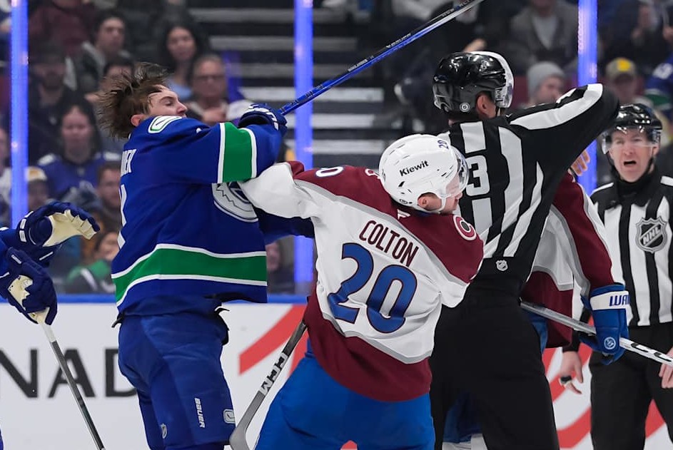 VANCOUVER, CANADA - FEBRUARY 4: Ross Colton #20 of the Colorado Avalanche is checked by Nils Hoglander #21 of the Vancouver Canucks during the third period at Rogers Arena on February 4, 2025 in Vancouver, British Columbia, Canada. (Photo by Derek Cain/Getty Images)