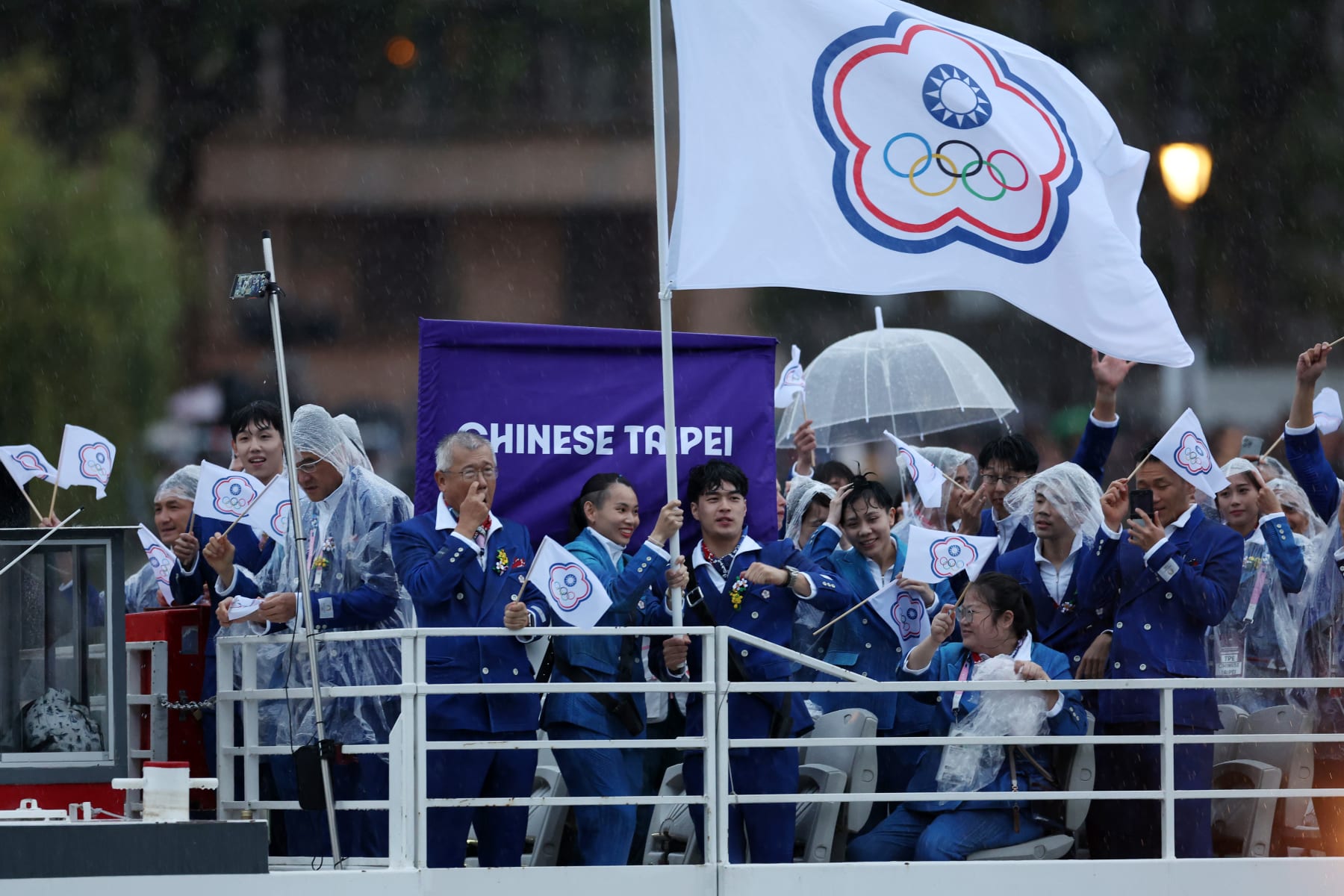 PARIS, FRANCE - JULY 26: Quake and Tzu Ying Tai, Flagbearers of Team Chinese Taipei, are seen on a boat waving their flag along the River Seine during the opening ceremony of the Olympic Games Paris 2024 on July 26, 2024 in Paris, France. (Photo by Maja Hitij/Getty Images)