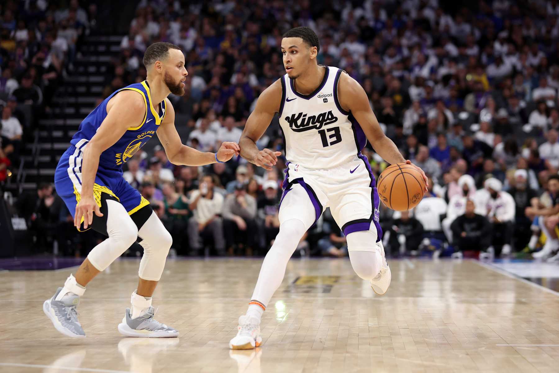 SACRAMENTO, CALIFORNIA - APRIL 16: Keegan Murray #13 of the Sacramento Kings is guarded by Stephen Curry #30 of the Golden State Warriors in the second half during the Play-In Tournament at Golden 1 Center on April 16, 2024 in Sacramento, California. NOTE TO USER: User expressly acknowledges and agrees that, by downloading and or using this photograph, User is consenting to the terms and conditions of the Getty Images License Agreement. (Photo by Ezra Shaw/Getty Images)