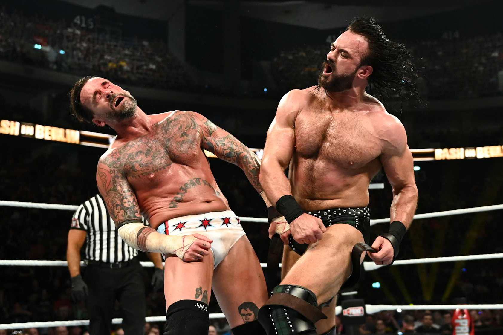 BERLIN, GERMANY - AUGUST 31: Drew McIntyre (R) connects with a punch against CM Punk during their strap match at the WWE Bash in Berlin Premium Live Event at Uber Arena on August 31, 2024 in Berlin, Germany. (Photo by WWE/Getty Images)