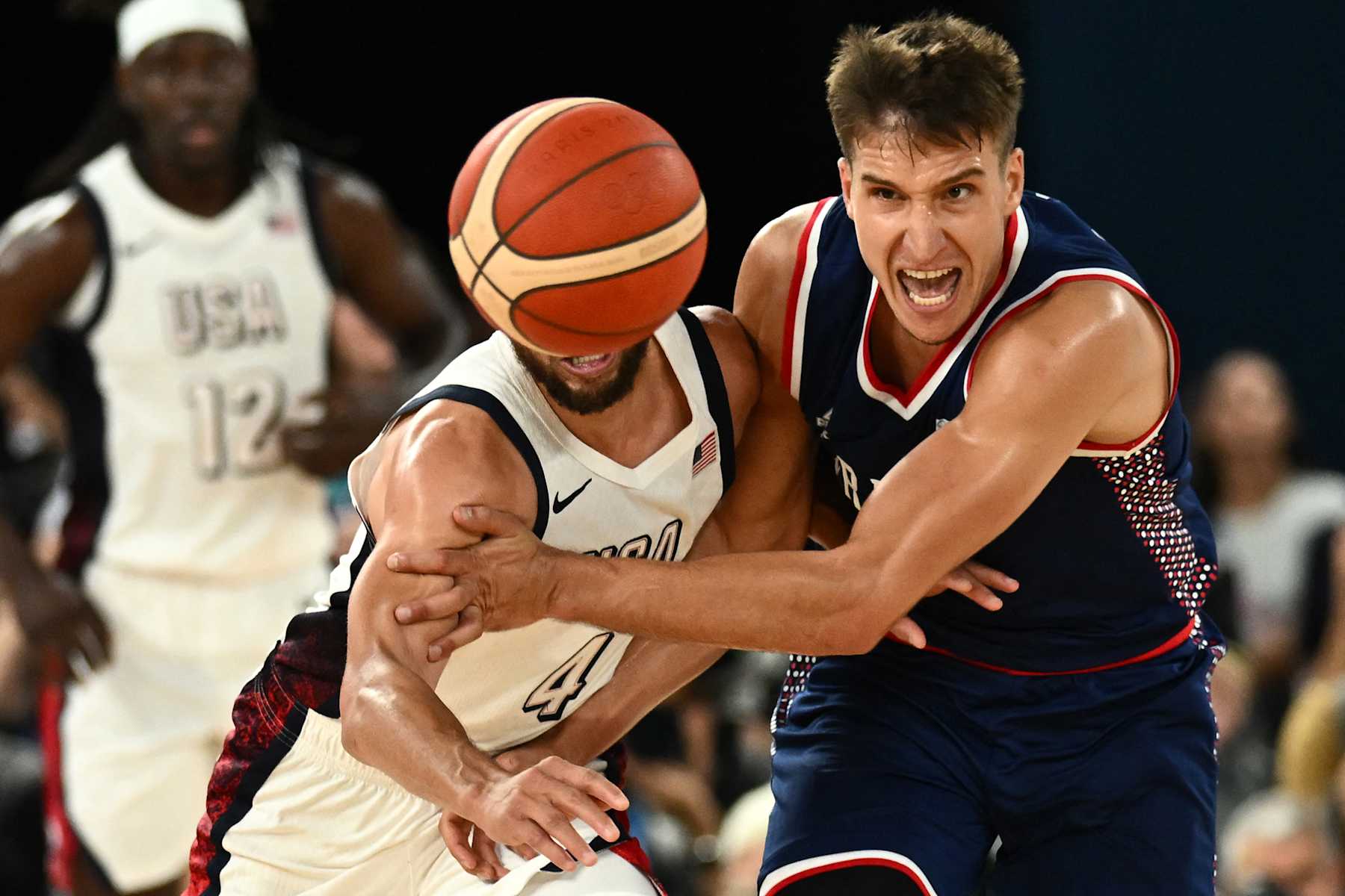 USA's #04 Stephen Curry (L) and Serbia's #07 Bogdan Bogdanovic fight for the ball in the men's semifinal basketball match between USA and Serbia during the Paris 2024 Olympic Games at the Bercy  Arena in Paris on August 8, 2024. (Photo by Aris MESSINIS / AFP) (Photo by ARIS MESSINIS/AFP via Getty Images)