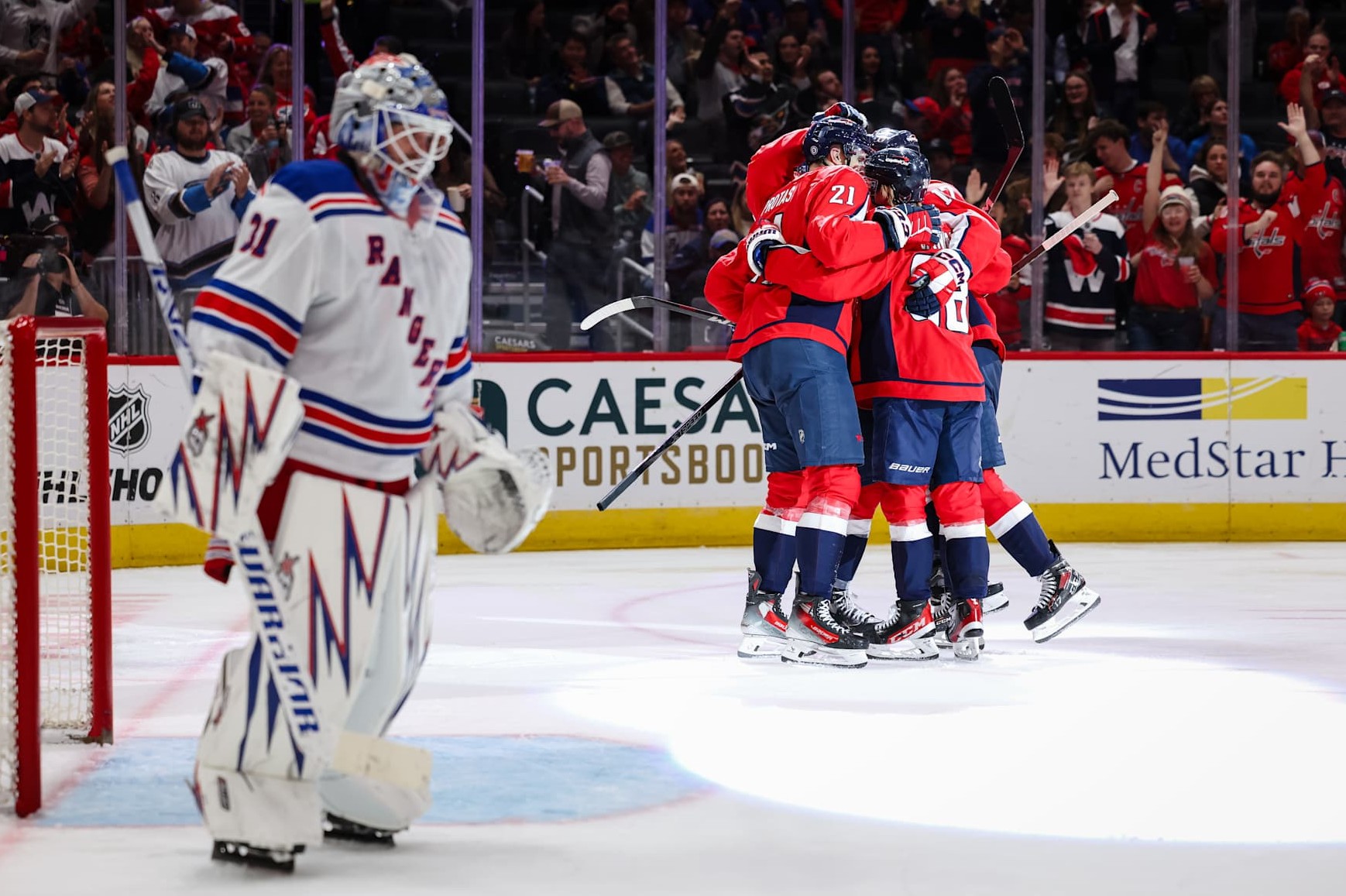 WASHINGTON, DC - OCTOBER 29: Aliaksei Protas #21 of the Washington Capitals celebrates with Trevor van Riemsdyk #57, Rasmus Sandin #38, and Dylan Strome #17 after scoring a goal against Igor Shesterkin #31 of the New York Rangers during the second period of the game at Capital One Arena on October 29, 2024 in Washington, DC. (Photo by Scott Taetsch/Getty Images)