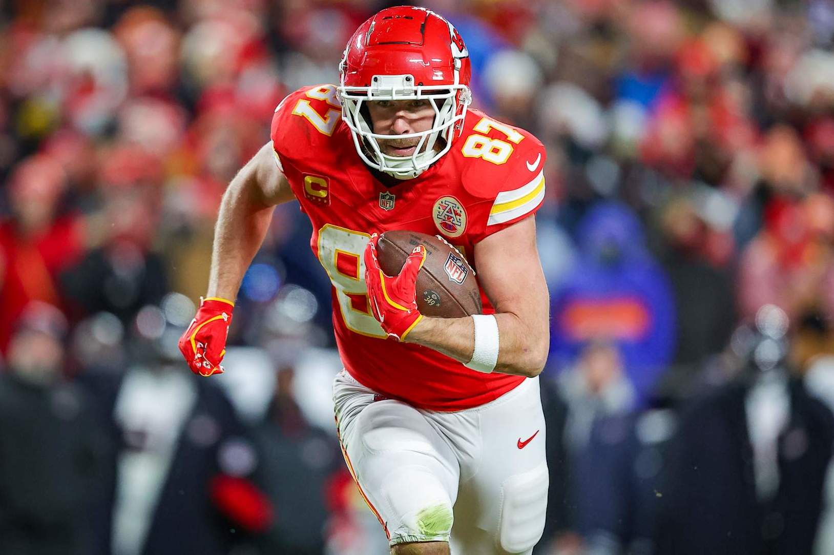 KANSAS CITY, MISSOURI - JANUARY 18: Travis Kelce #87 of the Kansas City Chiefs runs for yardage after a third quarter pass catch in the Divisional Round playoff at GEHA Field at Arrowhead Stadium on January 18, 2025 in Kansas City, Missouri. (Photo by David Eulitt/Getty Images)