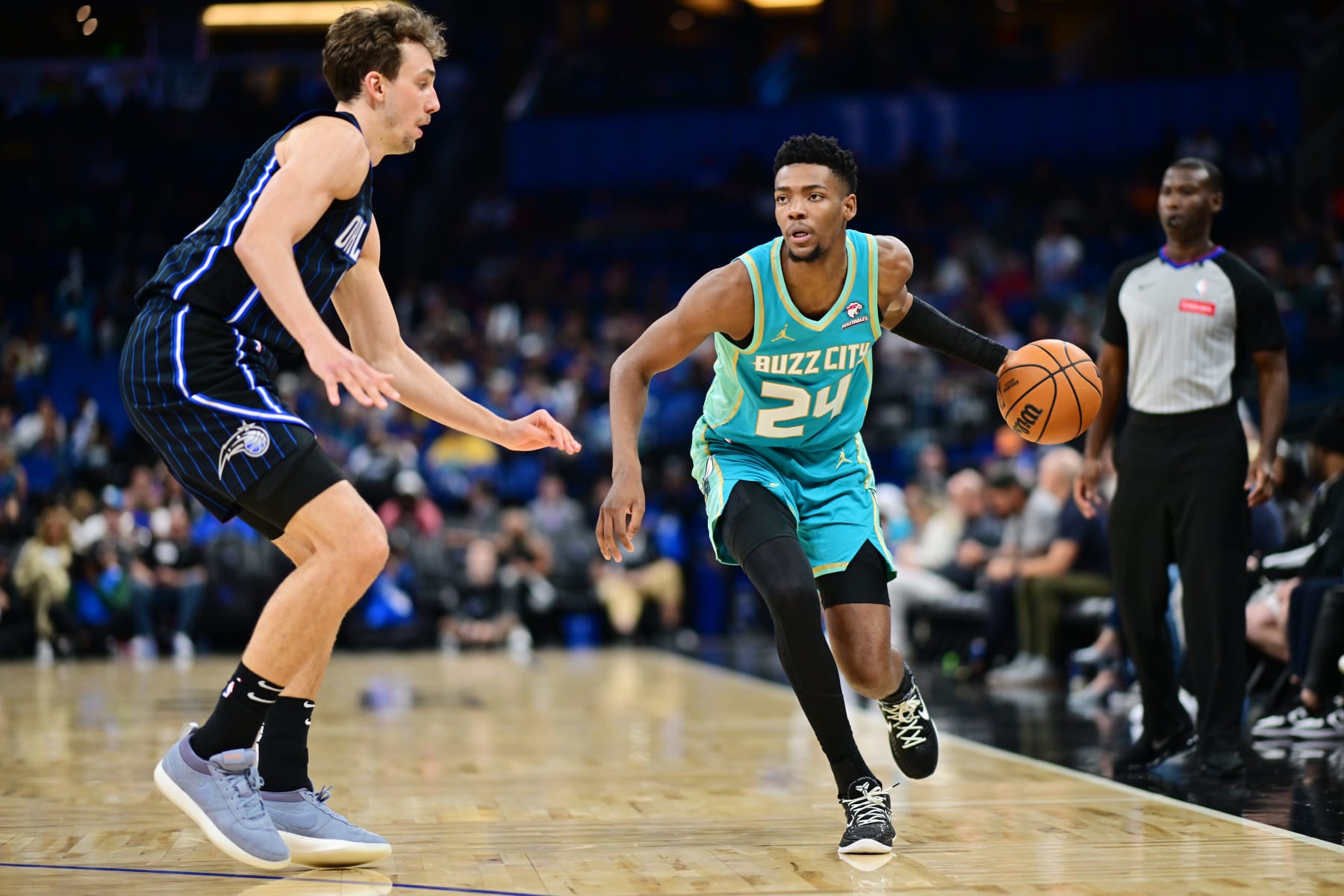 ORLANDO, FLORIDA - MARCH 19: Brandon Miller #24 of the Charlotte Hornets drives to the basket against Franz Wagner #22 of the Orlando Magic in the second half of a game at Kia Center on March 19, 2024 in Orlando, Florida. NOTE TO USER: User expressly acknowledges and agrees that, by downloading and or using this photograph, User is consenting to the terms and conditions of the Getty Images License Agreement. (Photo by Julio Aguilar/Getty Images)