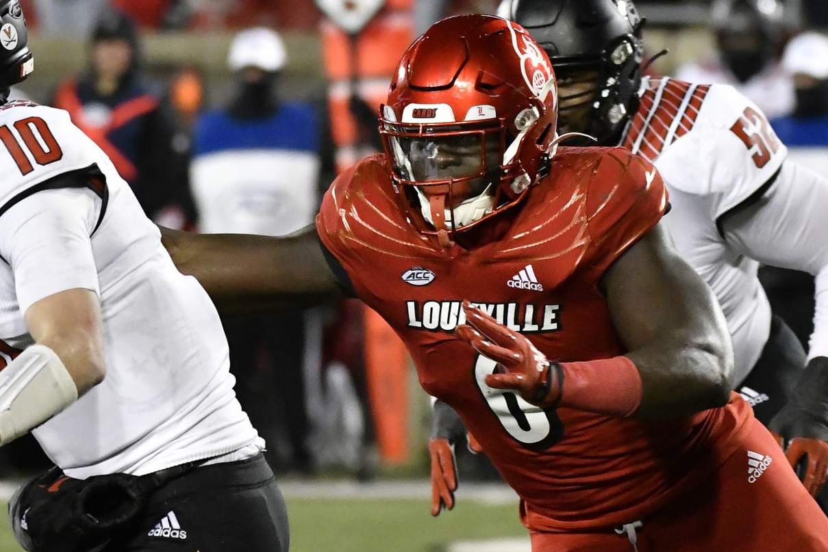 Louisville defensive lineman YaYa Diaby (6) attempts to grab North Carolina State quarterback Ben Finley (10) during the second half of an NCAA college football game in Louisville, Ky., Saturday, Nov. 19, 2022. (AP Photo/Timothy D. Easley)