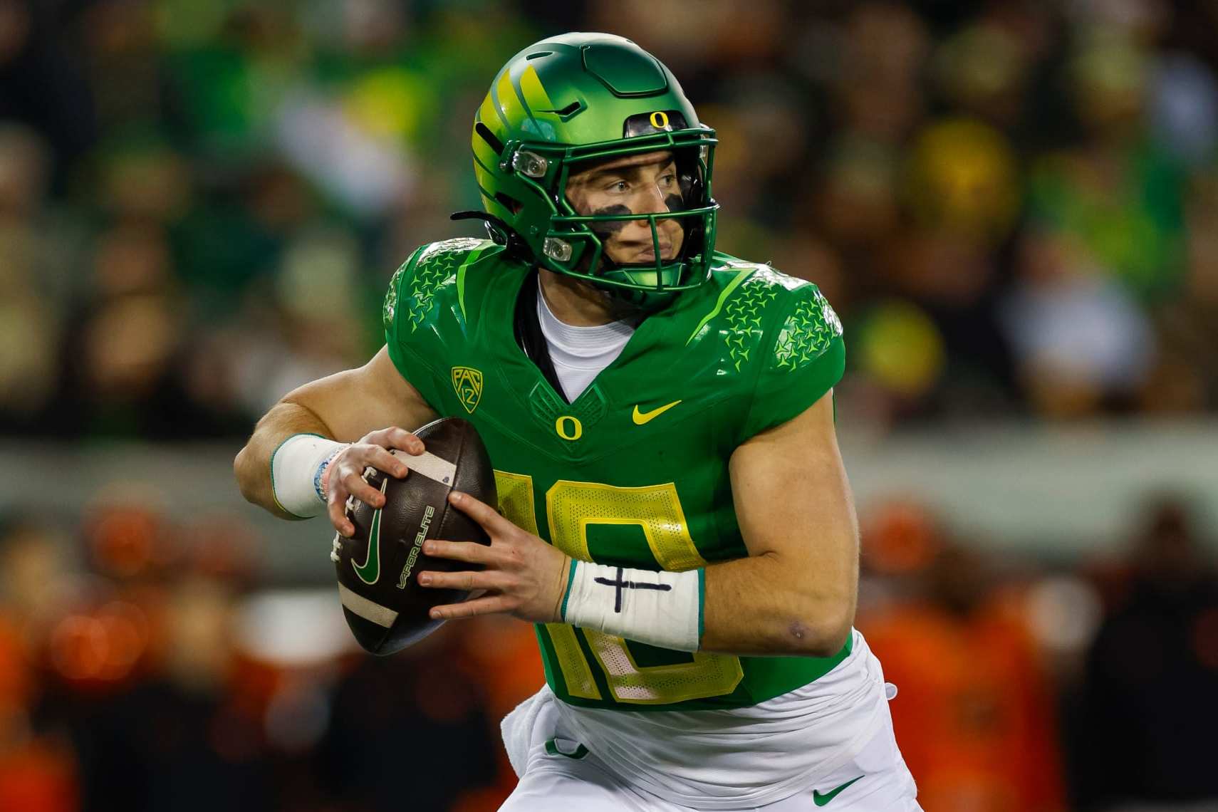 EUGENE, OREGON - NOVEMBER 24: Bo Nix #10 of the Oregon Ducks rolls out to pass during a game against the Oregon State Beavers at Autzen Stadium on November 24, 2023 in Eugene, Oregon. (Photo by Brandon Sloter/Image Of Sport/Getty Images)