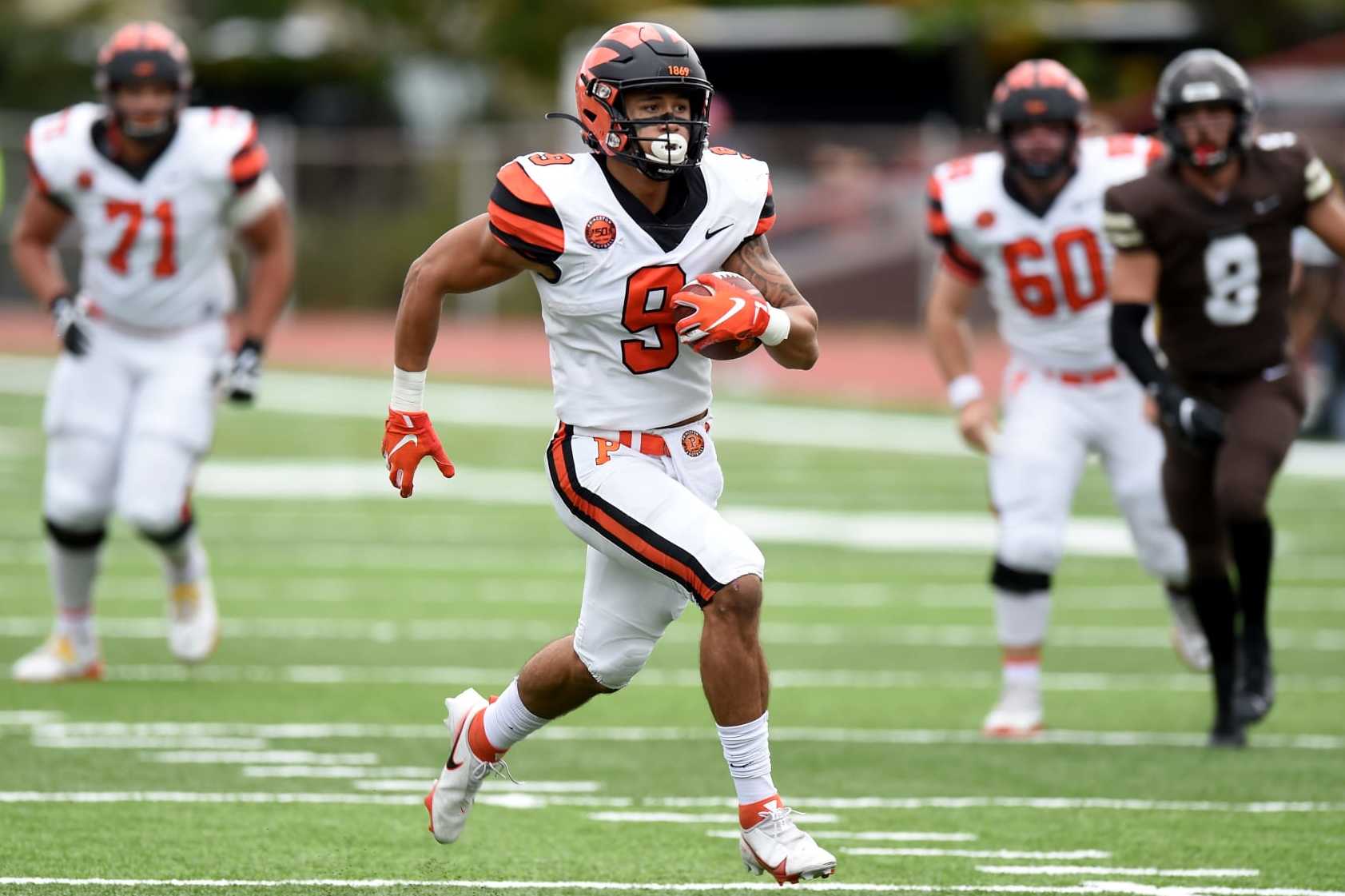 PROVIDENCE, RI - OCTOBER 16:  Andrei Iosivas #9 of the Princeton Tigers runs for a touchtown after making a catch against the Brown Bears at Brown Stadium on October 16, 2021 in Providence, Rhode Island.  (Photo by G Fiume/Getty Images)