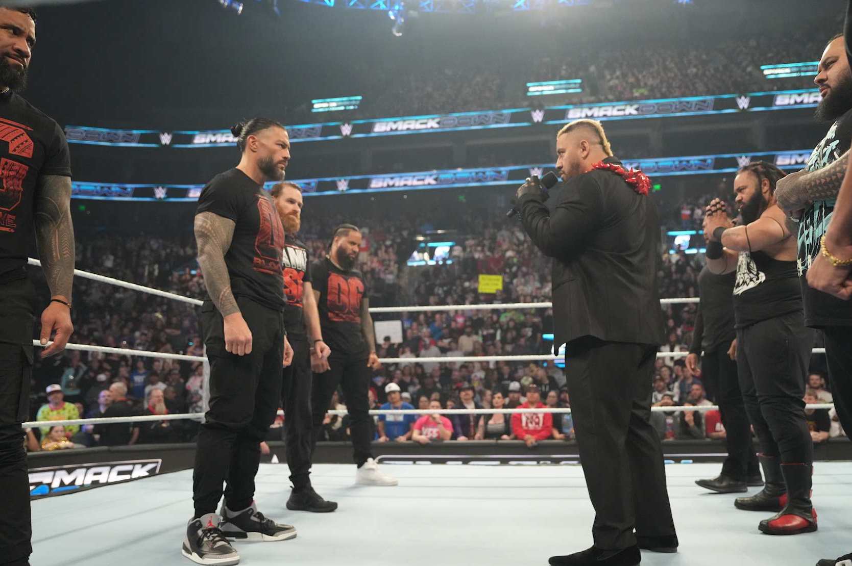 SALT LAKE CITY, UTAH - NOVEMBER 22: Jey Uso, Sami Zayn, Roman Reigns, Jimmy Uso and Silo Sikoa on microphone in ring with Jacob Fatu, Bronson Reed and Tama Tonga during WWE SmackDown at Delta Center on November 22, 2024 in Salt Lake City, Utah.  (Photo by WWE/Getty Images)
