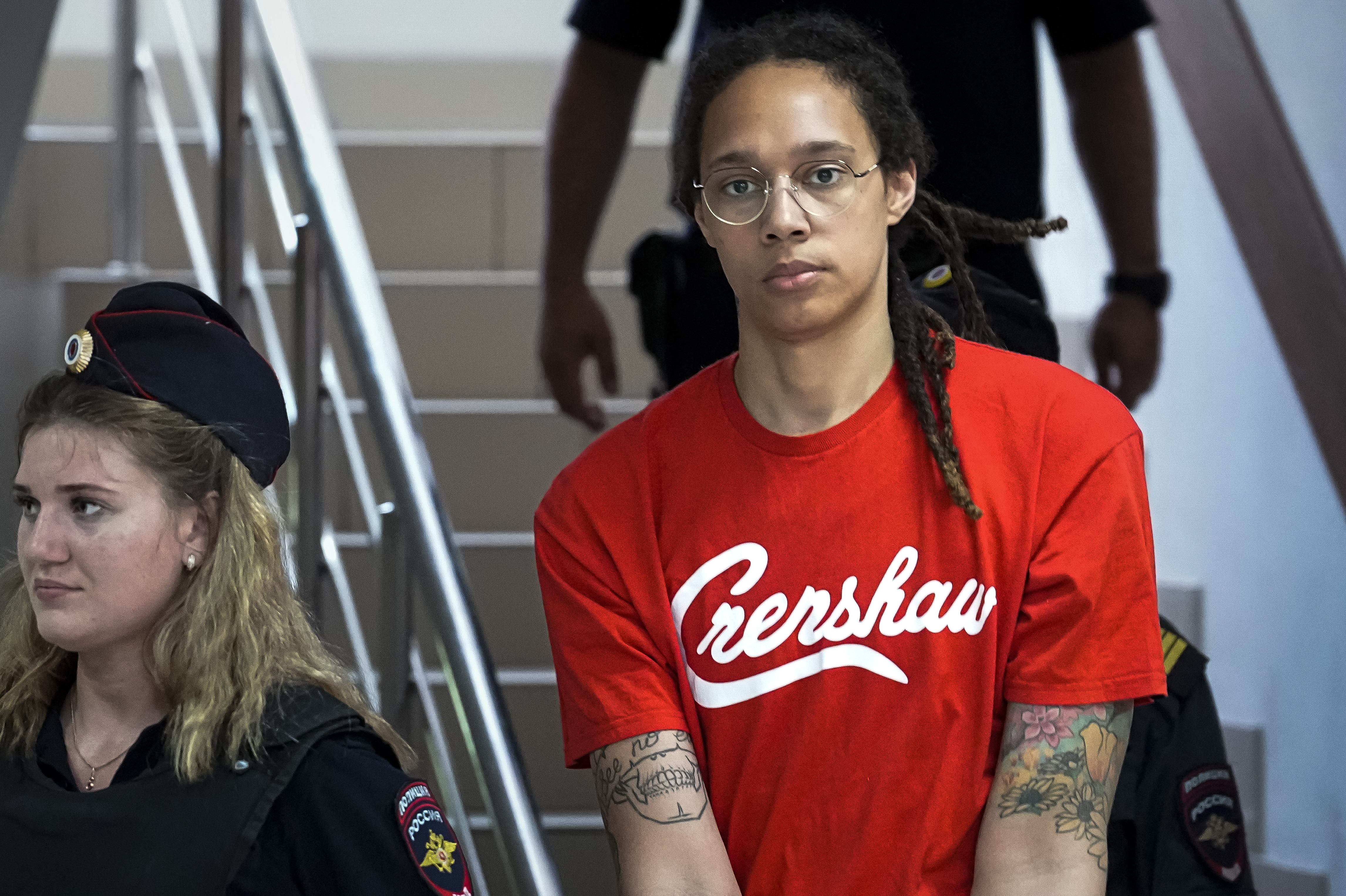 WNBA star and two-time Olympic gold medalist Brittney Griner is escorted to a courtroom for a hearing, in Khimki just outside Moscow, Russia, Thursday, July 7, 2022. Griner pleaded guilty Thursday to drug possession charges on the second day of her trial in a Russian court in a case that could see her sentenced to up to 10 years in prison. (AP Photo/Alexander Zemlianichenko)