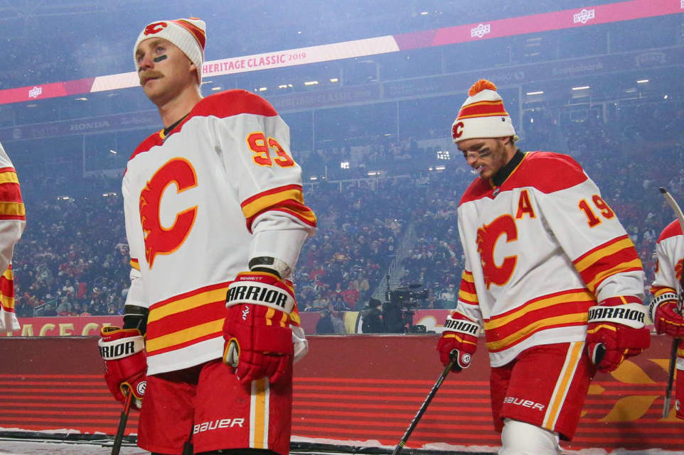 REGINA, SK - OCTOBER 26: Milan Lucic #17, Sam Bennett #93 and Matthew Tkachuk #19 of the Calgary Flames walk to the ice before taking on the Winnipeg Jets during the 2019 Tim Hortons NHL Heritage Classic at Mosaic Stadium on October 26, 2019 in Regina, Saskatchewan, Canada. (Photo by Andre Ringuette/NHLI via Getty Images)