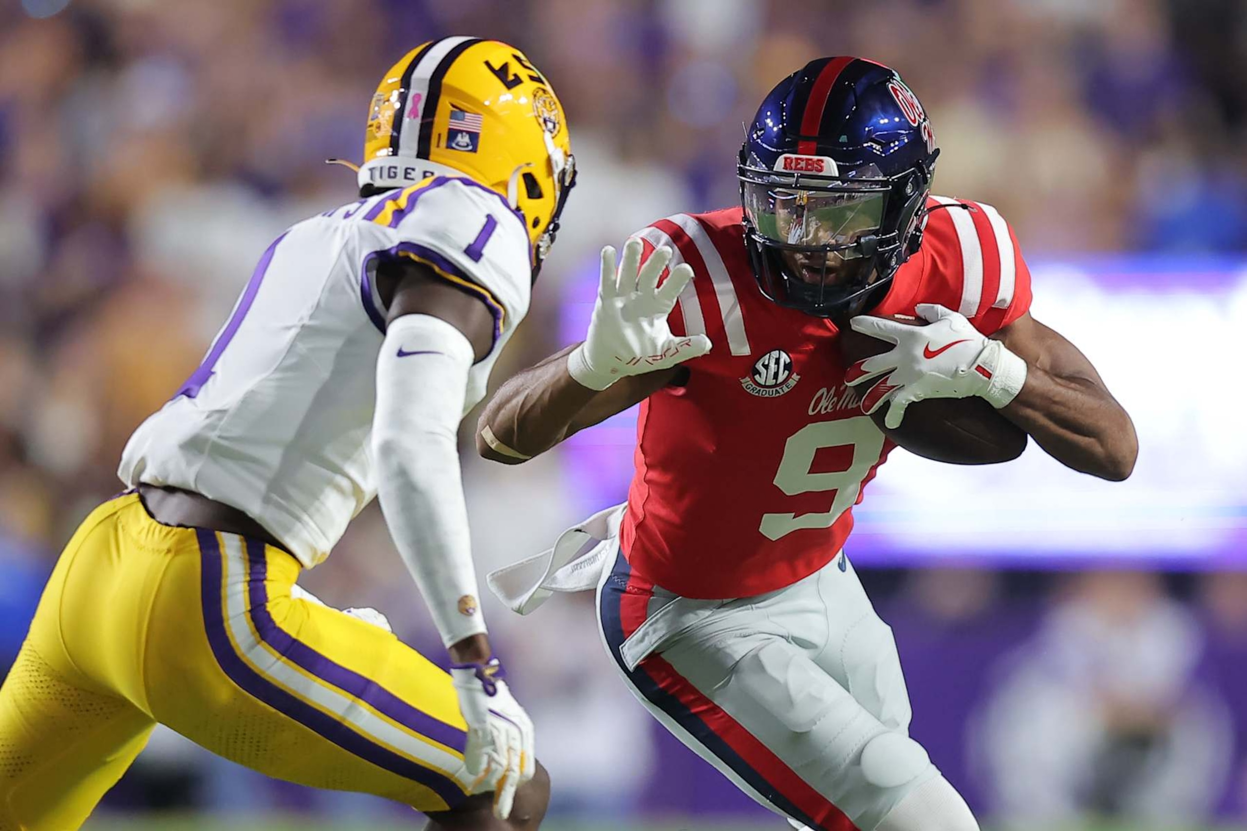 BATON ROUGE, LOUISIANA - OCTOBER 12: Tre Harris #9 of the Mississippi Rebels runs with the ball as Ashton Stamps #1 of the LSU Tigers defends during the first half of a game at Tiger Stadium on October 12, 2024 in Baton Rouge, Louisiana. (Photo by Jonathan Bachman/Getty Images)