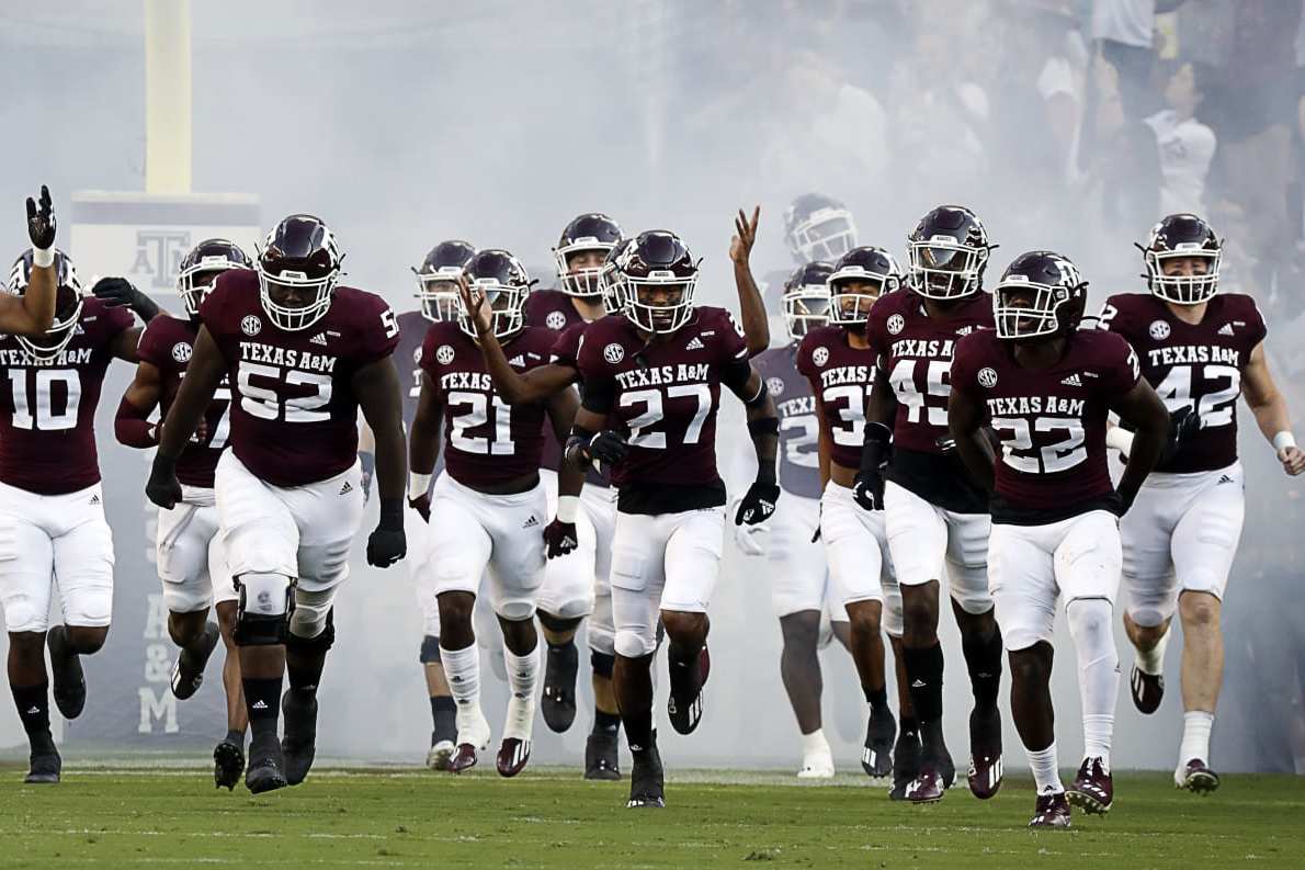 COLLEGE STATION, TEXAS - OCTOBER 02: head coach Jimbo Fisher of the Texas A&M Aggies brings his team onto the field against the Mississippi State Bulldogs at Kyle Field on October 02, 2021 in College Station, Texas. (Photo by Bob Levey/Getty Images)