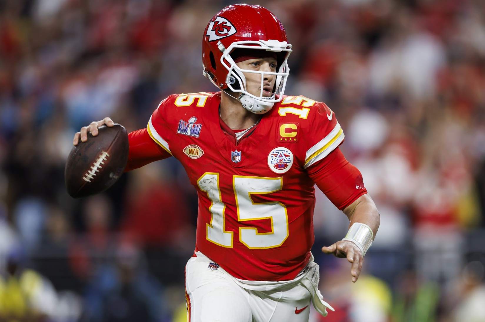 LAS VEGAS, NEVADA - FEBRUARY 11: Patrick Mahomes #15 of the Kansas City Chiefs rolls out and looks to throw a pass to Mecole Hardman Jr. to score the game-winning touchdown during Super Bowl LVIII against the San Francisco 49ers at Allegiant Stadium on February 11, 2024 in Las Vegas, Nevada. (Photo by Ryan Kang/Getty Images)