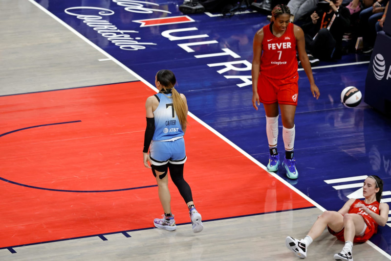 INDIANAPOLIS, IN - JUNE 01: Chicago Sky guard Chennedy Carter (7) is whistled for a flagrant foul for knocking Indiana Fever guard Caitlin Clark (22) to the ground on June 1, 2024, at Gainbridge Fieldhouse in Indianapolis, Indiana. (Photo by Brian Spurlock/Icon Sportswire via Getty Images)