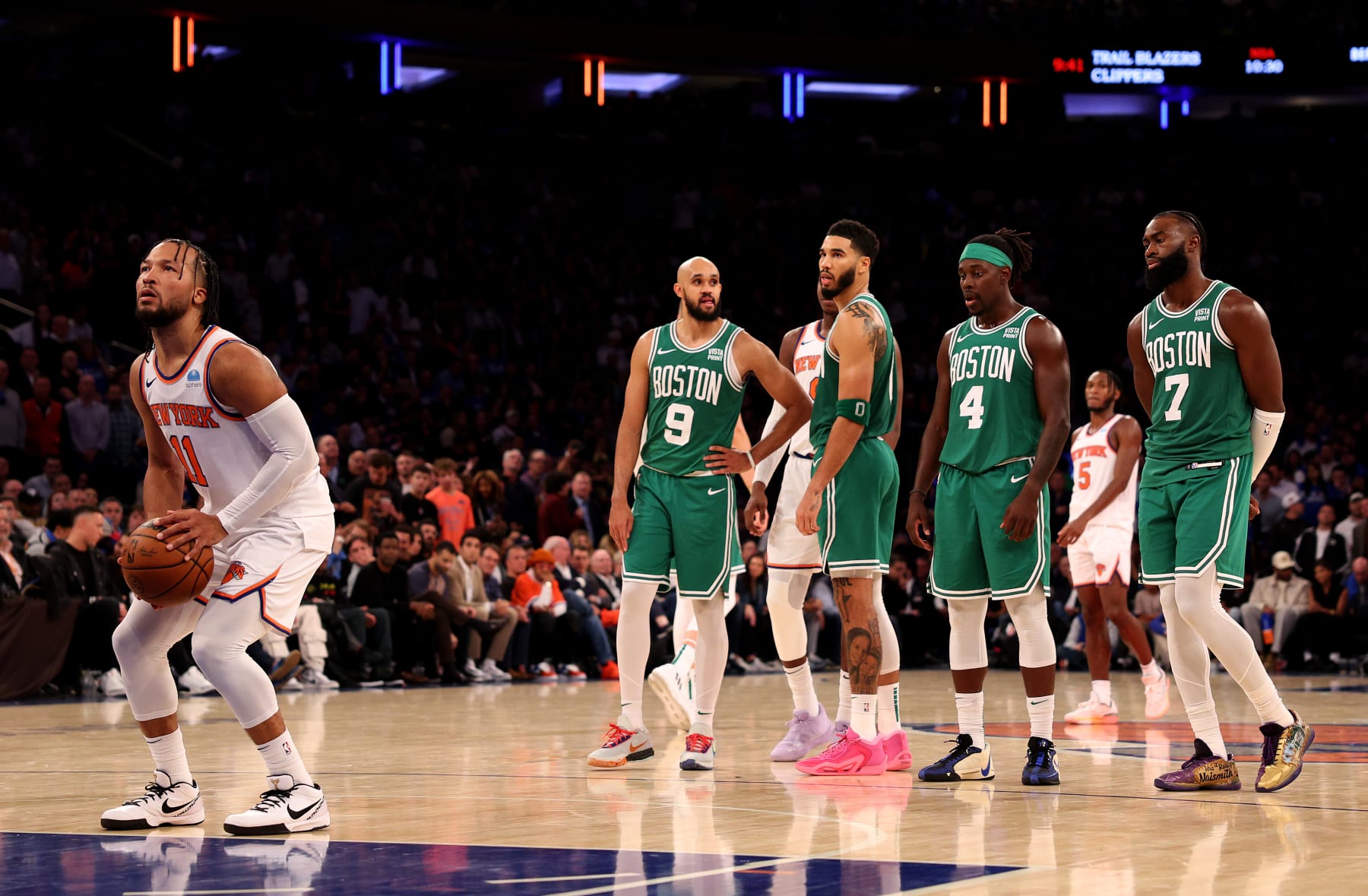 NEW YORK, NEW YORK - OCTOBER 25:  Jalen Brunson #11 of the New York Knicks attempts a free throw as Derrick White #9,Jayson Tatum #0,Jrue Holiday #4 and Jaylen Brown #7 of the Boston Celtics look on at Madison Square Garden on October 25, 2023 in New York City. NOTE TO USER: User expressly acknowledges and agrees that, by downloading and or using this photograph, User is consenting to the terms and conditions of the Getty Images License Agreement. (Photo by Elsa/Getty Images)