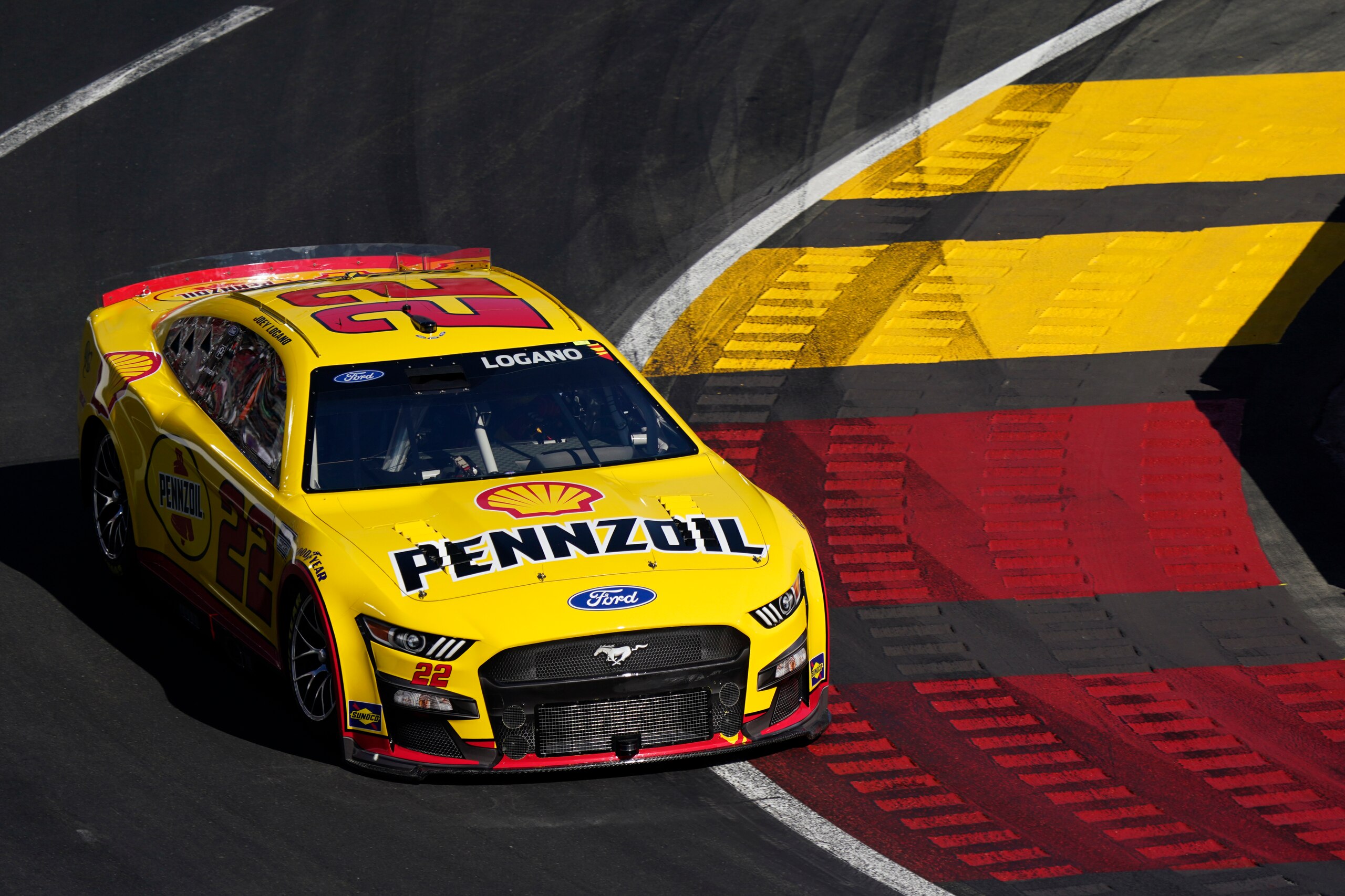 Joey Logano makes a turn during a heat race ahead of a NASCAR exhibition auto race at Los Angeles Memorial Coliseum, Sunday, Feb. 6, 2022, in Los Angeles. (AP Photo/Marcio Jose Sanchez)