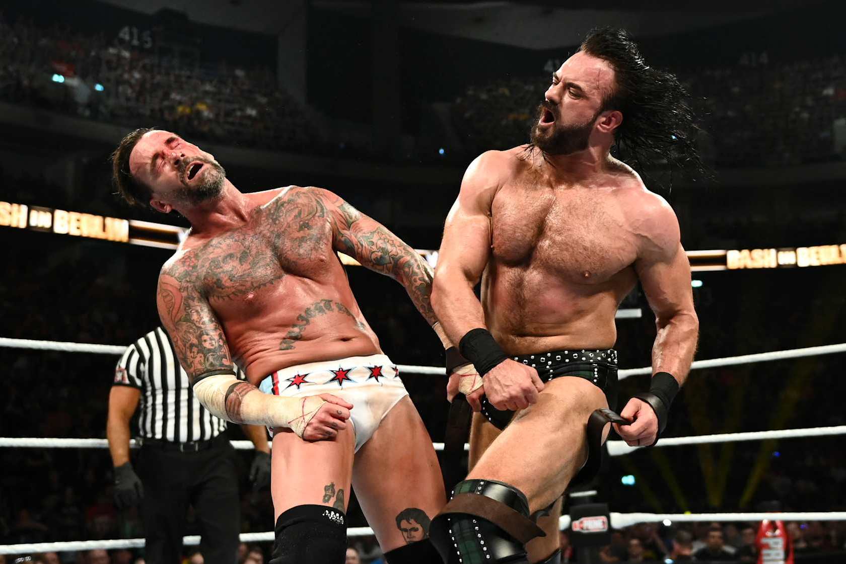 BERLIN, GERMANY - AUGUST 31: Drew McIntyre (R) connects with a punch against CM Punk during their strap match at the WWE Bash in Berlin Premium Live Event at Uber Arena on August 31, 2024 in Berlin, Germany. (Photo by WWE/Getty Images)