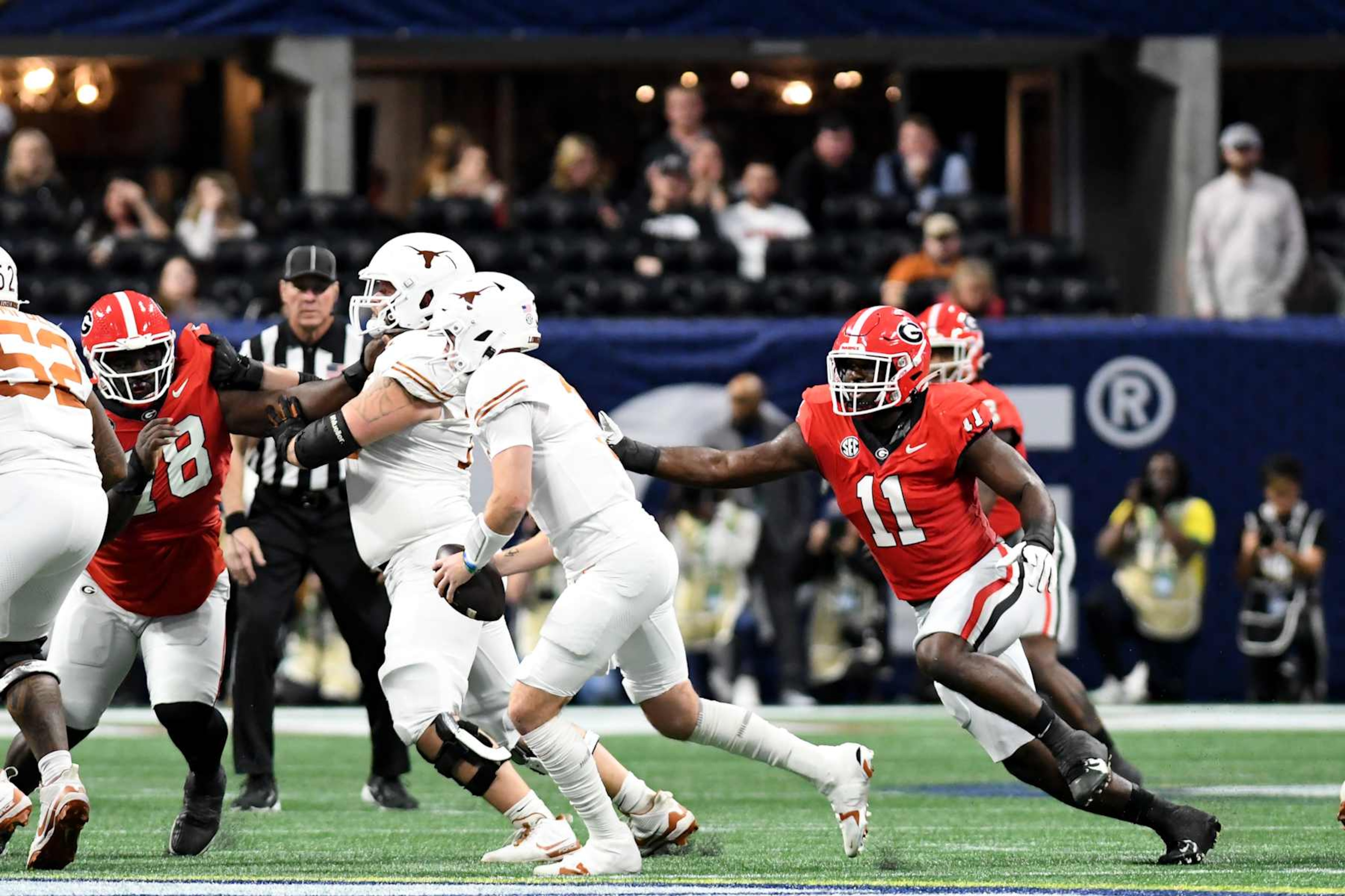 ATLANTA, GA - DECEMBER 7: Jalon Walker #11 of the Georgia Bulldogs pressures Quinn Ewers #3 of the Texas Longhorns during a game between University of Texas and University of Georgia at Mercedes-Benz Stadium on December 7, 2024 in Atlanta, Georgia. (Photo by Perry McIntyre/ISI Photos/Getty Images)