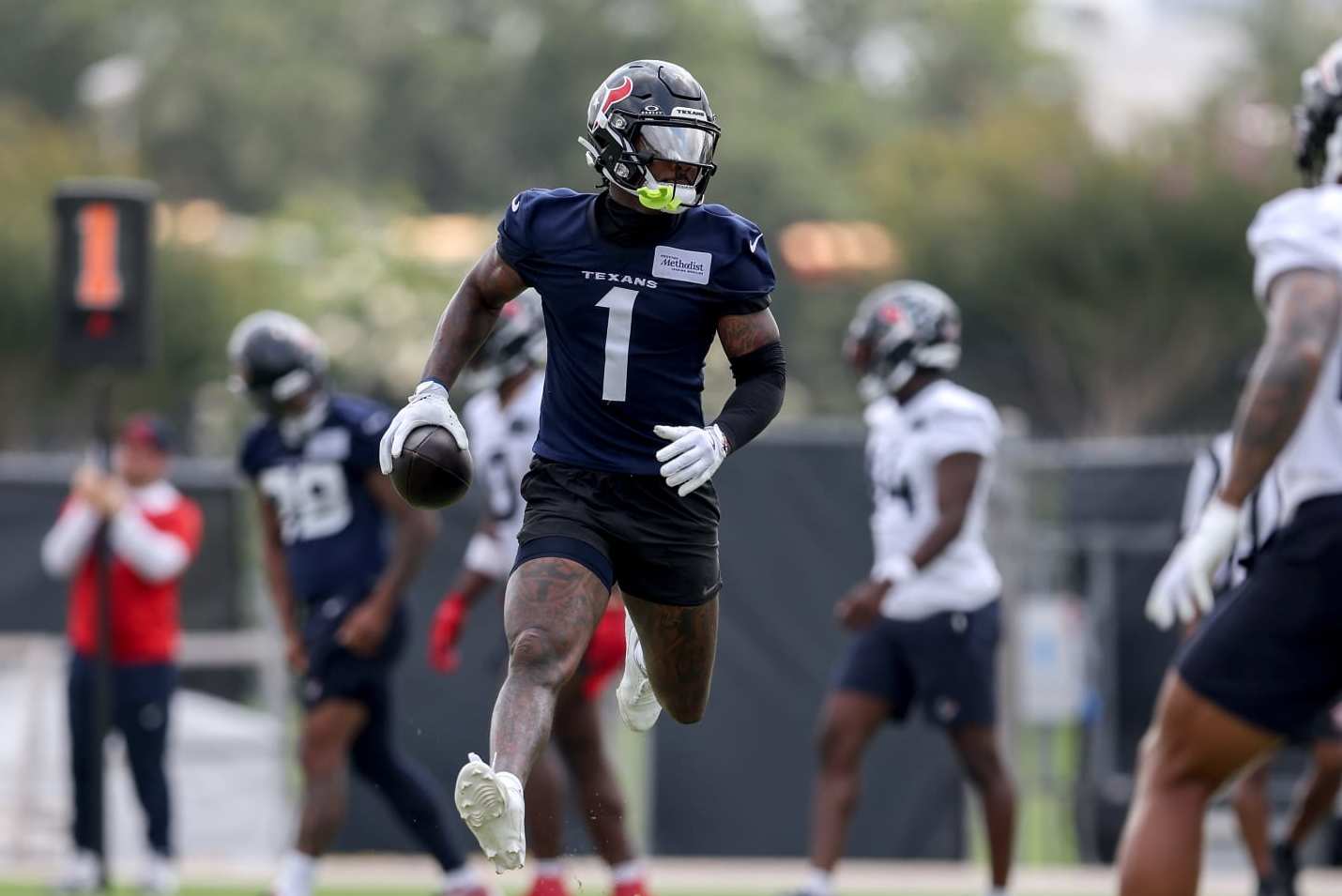 HOUSTON, TEXAS - JUNE 04: Stefon Diggs #1 of the Houston Texans runs after a catch during Mandatory Minicamp at Houston Methodist Training Center on June 04, 2024 in Houston, Texas. (Photo by Tim Warner/Getty Images)