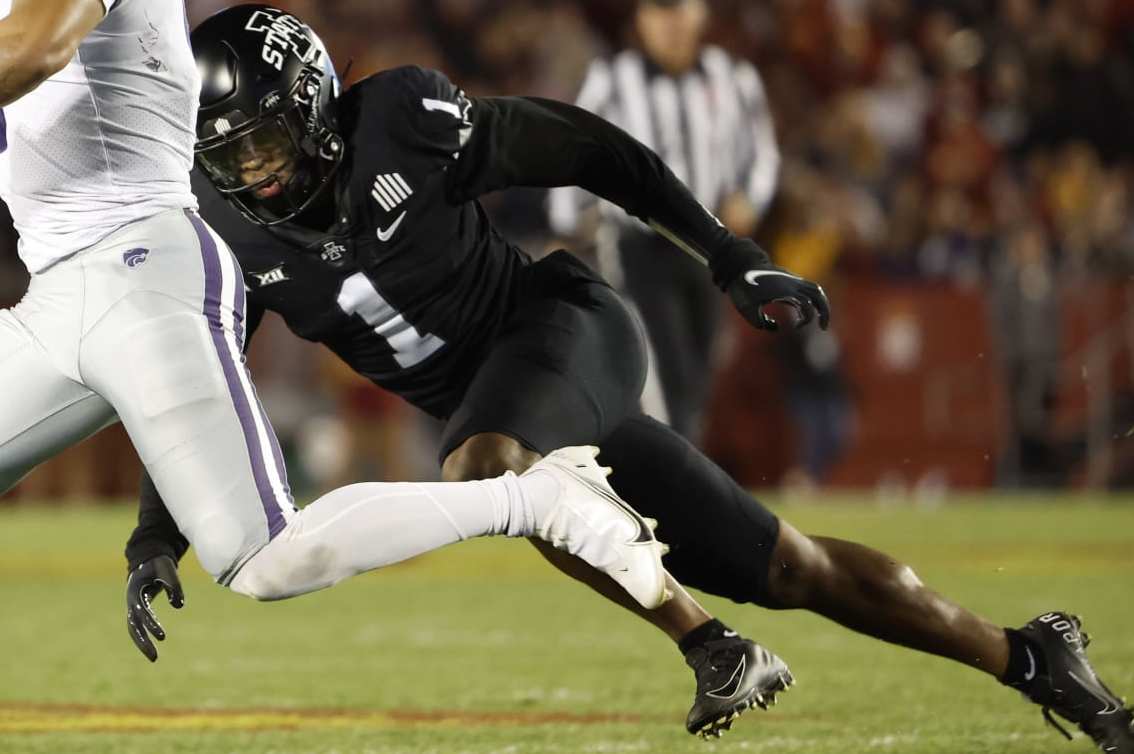 AMES, IA - OCTOBER 8:  Quarterback Adrian Martinez #9 of the Kansas State Wildcats scrambles for yards as defensive back Anthony Johnson Jr. #1 of the Iowa State Cyclones puts pressure on in the first half of play at Jack Trice Stadium on October 8, 2022 in Ames, Iowa. The Kansas State Wildcats won 10-9 over the Iowa State Cyclones. (Photo by David K Purdy/Getty Images)