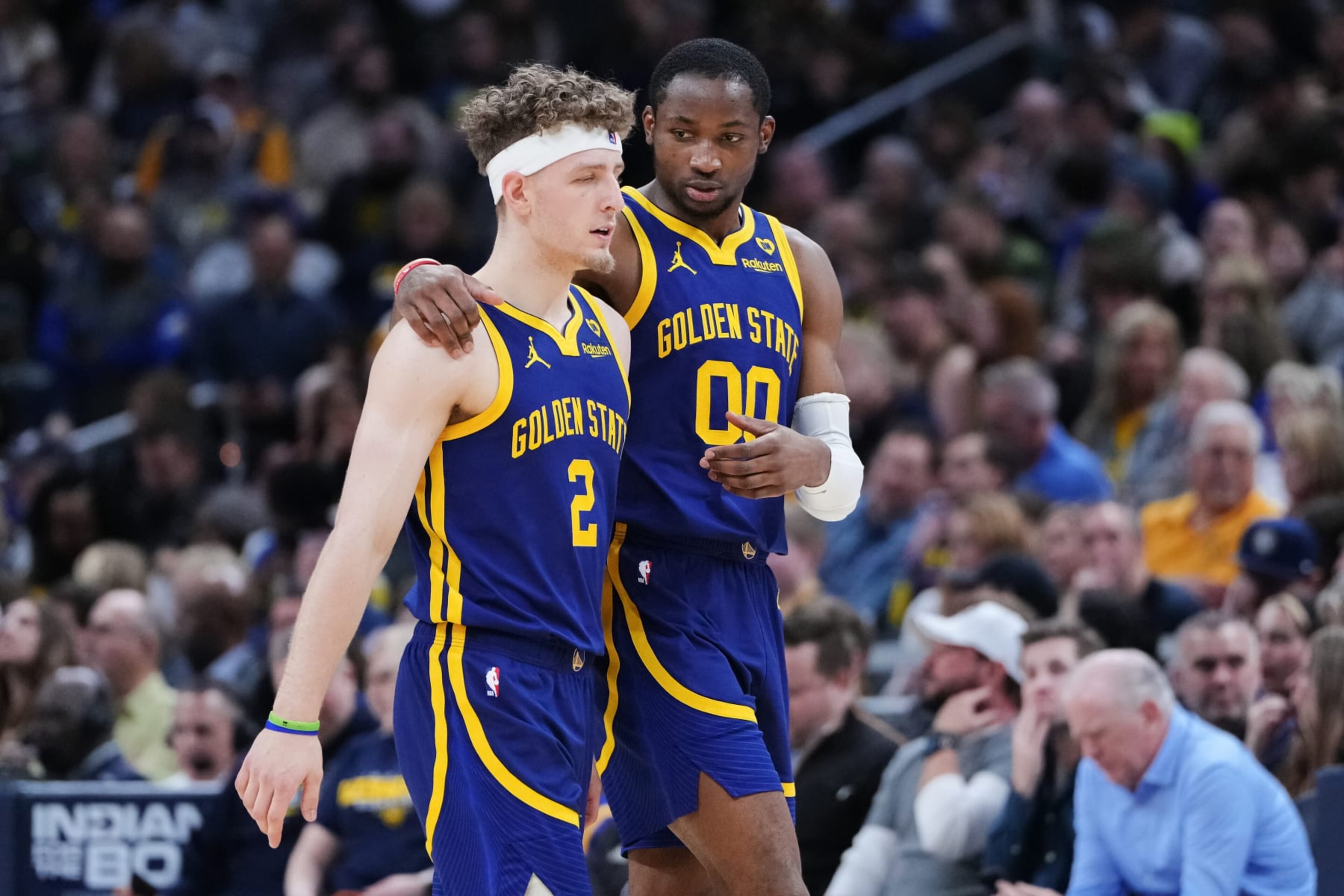 INDIANAPOLIS, INDIANA - FEBRUARY 08: Brandin Podziemski #2 and Jonathan Kuminga #00 of the Golden State Warriors walks across the court in the first quarter against the Indiana Pacers at Gainbridge Fieldhouse on February 08, 2024 in Indianapolis, Indiana. NOTE TO USER: User expressly acknowledges and agrees that, by downloading and or using this photograph, User is consenting to the terms and conditions of the Getty Images License Agreement. (Photo by Dylan Buell/Getty Images)
