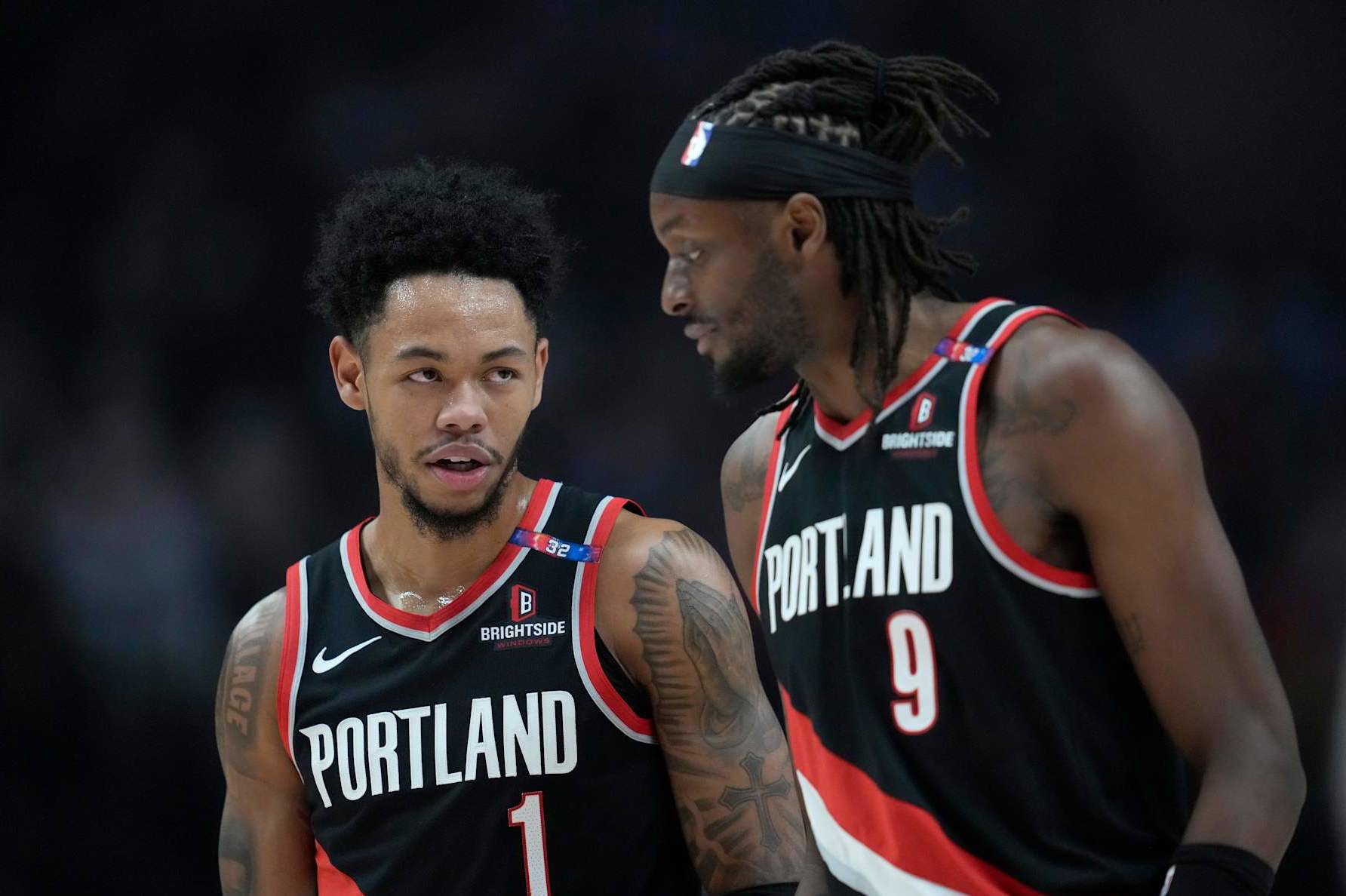 PORTLAND, OREGON - DECEMBER 01: Anfernee Simons #1 talks with Jerami Grant #9 of the Portland Trail Blazers during the first half against the Dallas Mavericks at Moda Center on December 01, 2024 in Portland, Oregon. NOTE TO USER: User expressly acknowledges and agrees that, by downloading and or using this photograph, User is consenting to the terms and conditions of the Getty Images License Agreement. (Photo by Soobum Im/Getty Images)