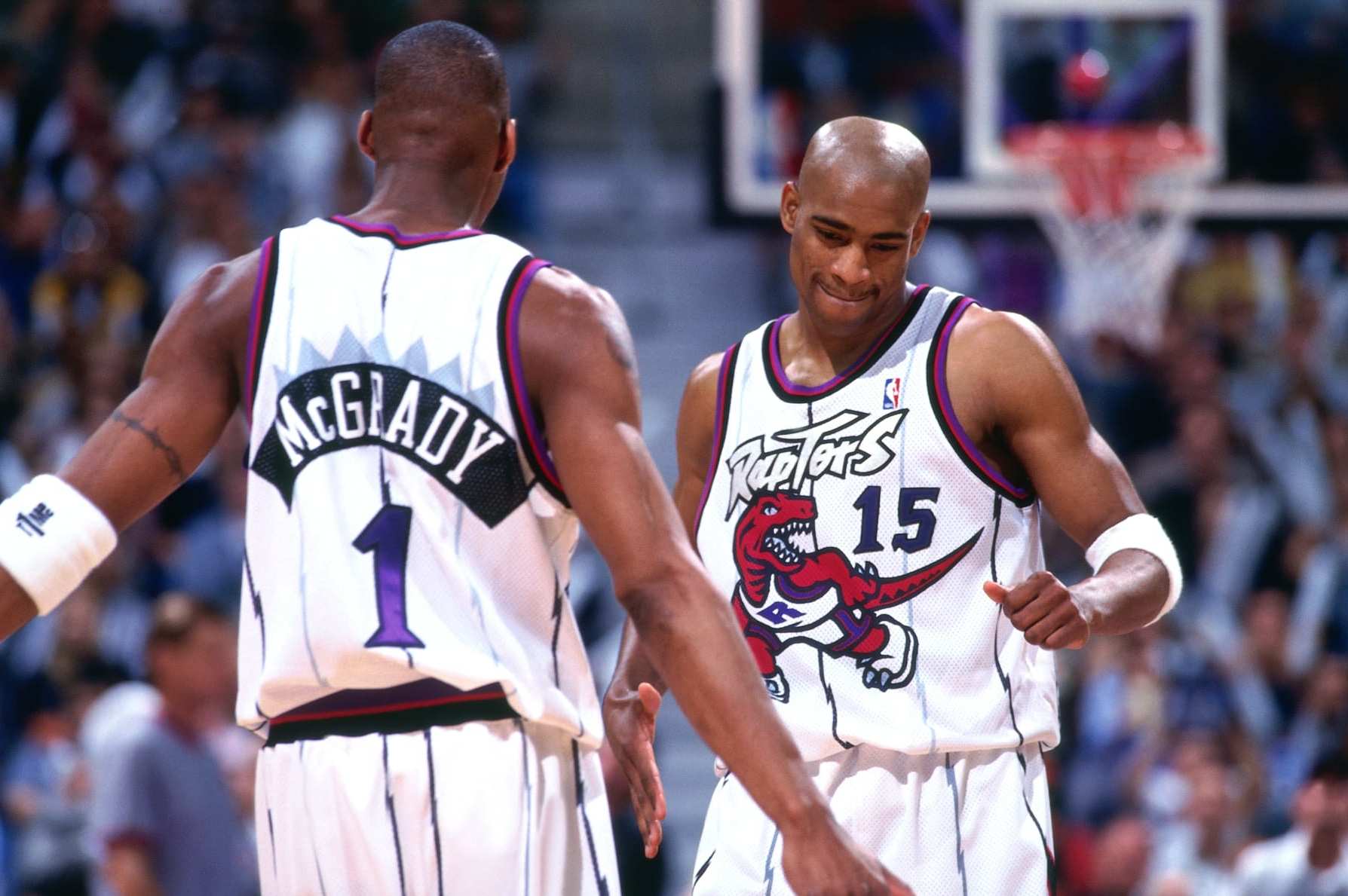 TORONTO - 1999: Tracy McGrady #1 and Vince Carter #15 of the Toronto Raptors look on circa 1999 at the Air Canada Centre in Toronto, Ontario. NOTE TO USER: User expressly acknowledges and agrees that, by downloading and or using this photograph, User is consenting to the terms and conditions of the Getty Images License Agreement. Mandatory Copyright Notice: Copyright 1999 NBAE (Photo by Ron Turenne/NBAE via Getty Images)
