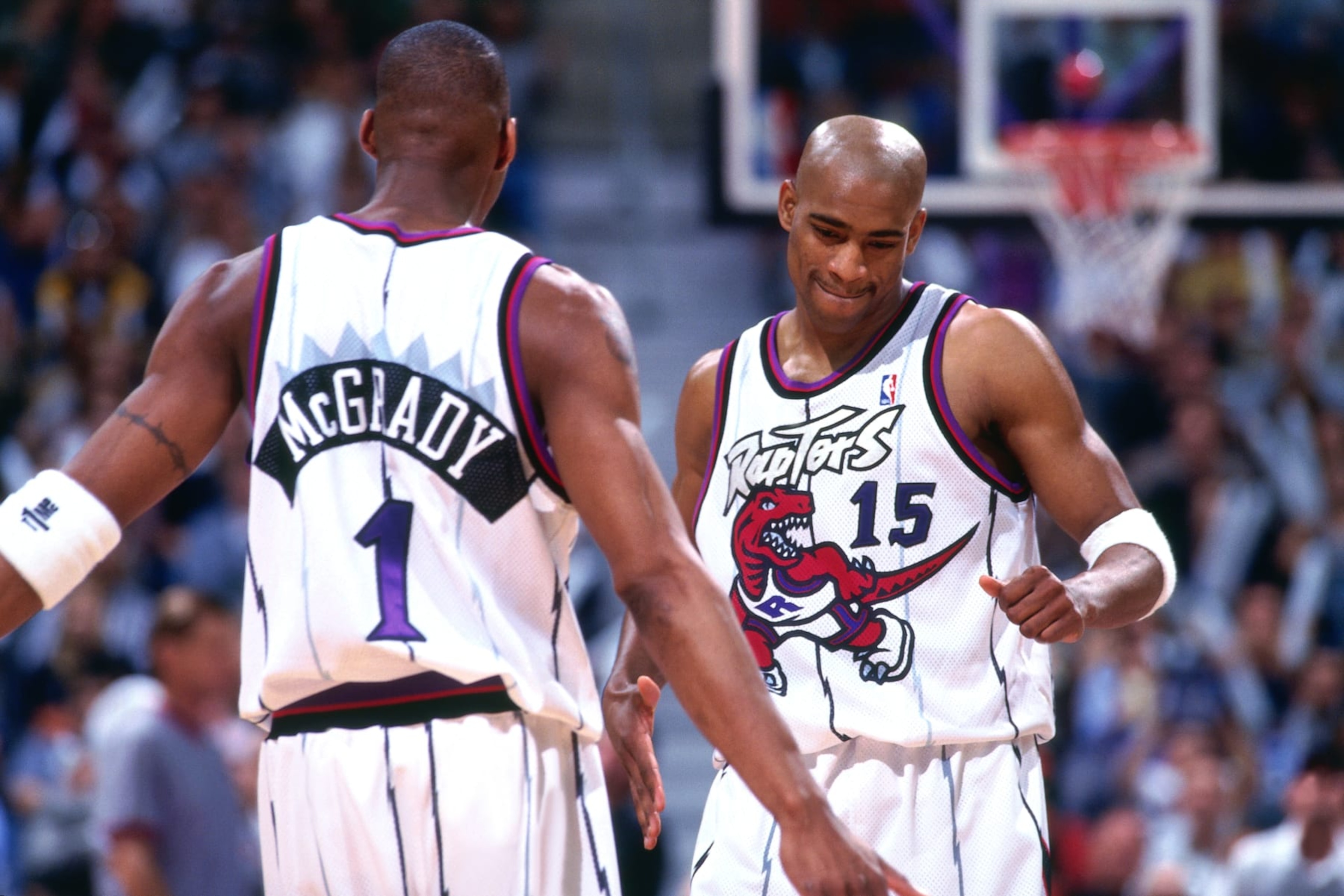 TORONTO - 1999: Tracy McGrady #1 and Vince Carter #15 of the Toronto Raptors look on circa 1999 at the Air Canada Centre in Toronto, Ontario. NOTE TO USER: User expressly acknowledges and agrees that, by downloading and or using this photograph, User is consenting to the terms and conditions of the Getty Images License Agreement. Mandatory Copyright Notice: Copyright 1999 NBAE (Photo by Ron Turenne/NBAE via Getty Images)