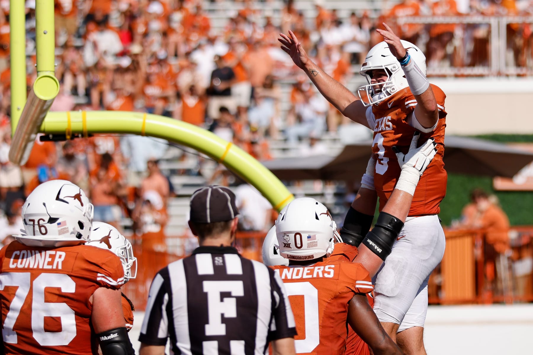 AUSTIN, TEXAS - SEPTEMBER 02: Quinn Ewers #3 of the Texas Longhorns is congratulated by teammates after a rushing touchdown in the third quarter against the Rice Owls at Darrell K Royal-Texas Memorial Stadium on September 02, 2023 in Austin, Texas. (Photo by Tim Warner/Getty Images)