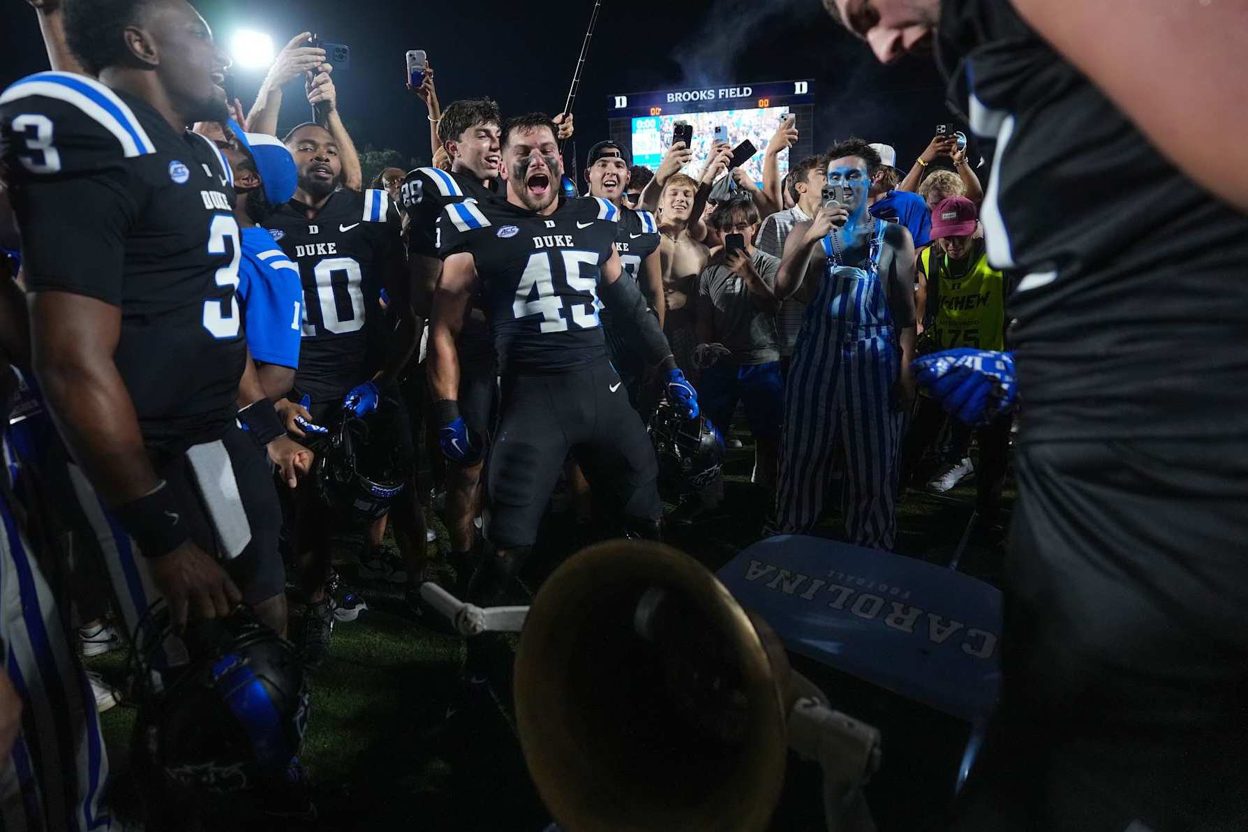 DURHAM, NORTH CAROLINA - SEPTEMBER 28: Duke Blue Devils players and fans celebrate with the Victory Bell after a win against the North Carolina Tar Heels at Wallace Wade Stadium on September 28, 2024 in Durham, North Carolina. Duke won 21-20. (Photo by Grant Halverson/Getty Images)