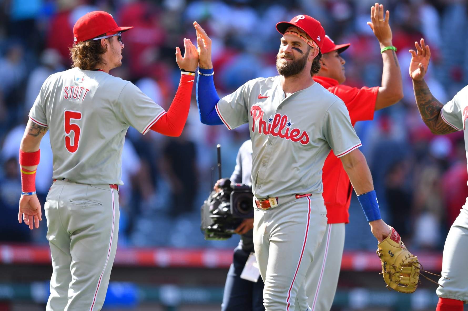ANAHEIM, CA - MAY 01: Philadelphia Phillies Second base Bryson Stott (5) gives Philadelphia Phillies first baseman Bryce Harper (3) a high five after the MLB game between the Philadelphia Phillies and the Los Angeles Angels of Anaheim on May 1, 2024 at Angel Stadium of Anaheim in Anaheim, CA. (Photo by Brian Rothmuller/Icon Sportswire via Getty Images)