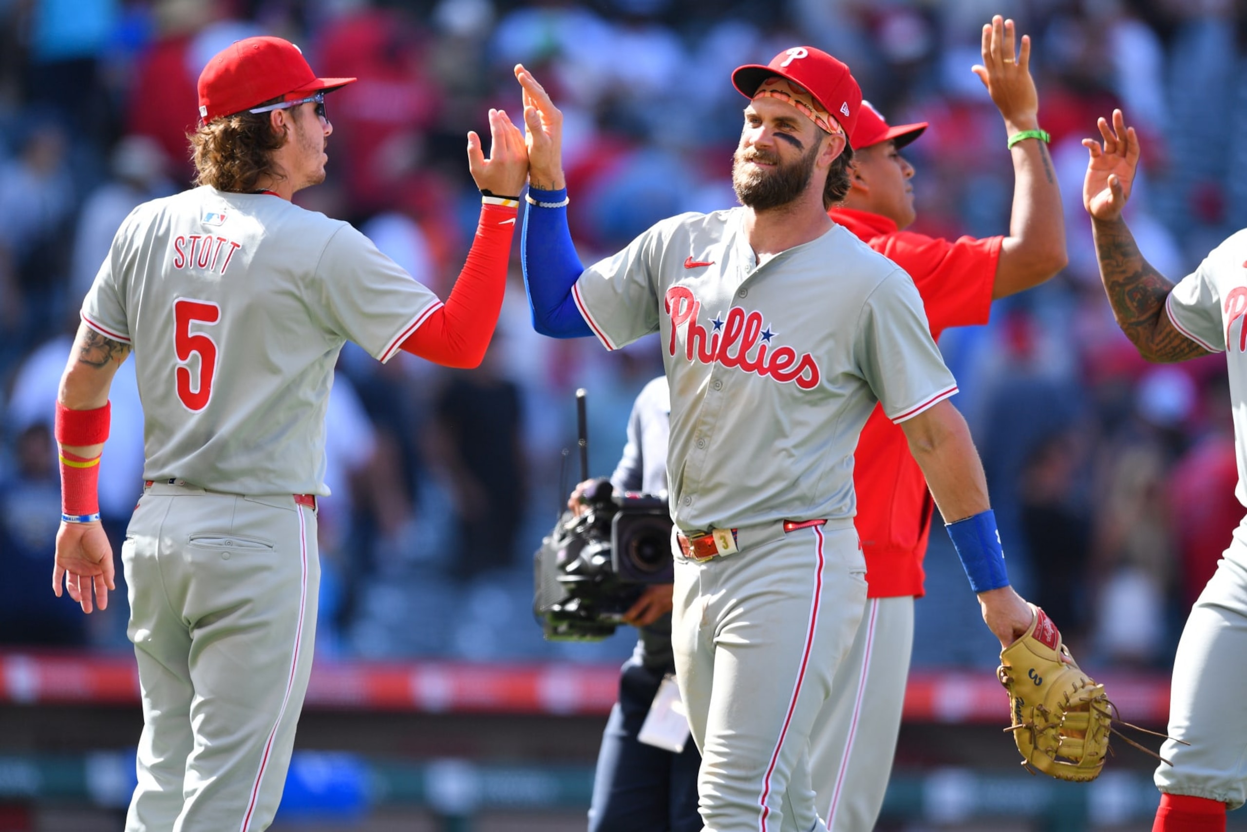 ANAHEIM, CA - MAY 01: Philadelphia Phillies Second base Bryson Stott (5) gives Philadelphia Phillies first baseman Bryce Harper (3) a high five after the MLB game between the Philadelphia Phillies and the Los Angeles Angels of Anaheim on May 1, 2024 at Angel Stadium of Anaheim in Anaheim, CA. (Photo by Brian Rothmuller/Icon Sportswire via Getty Images)
