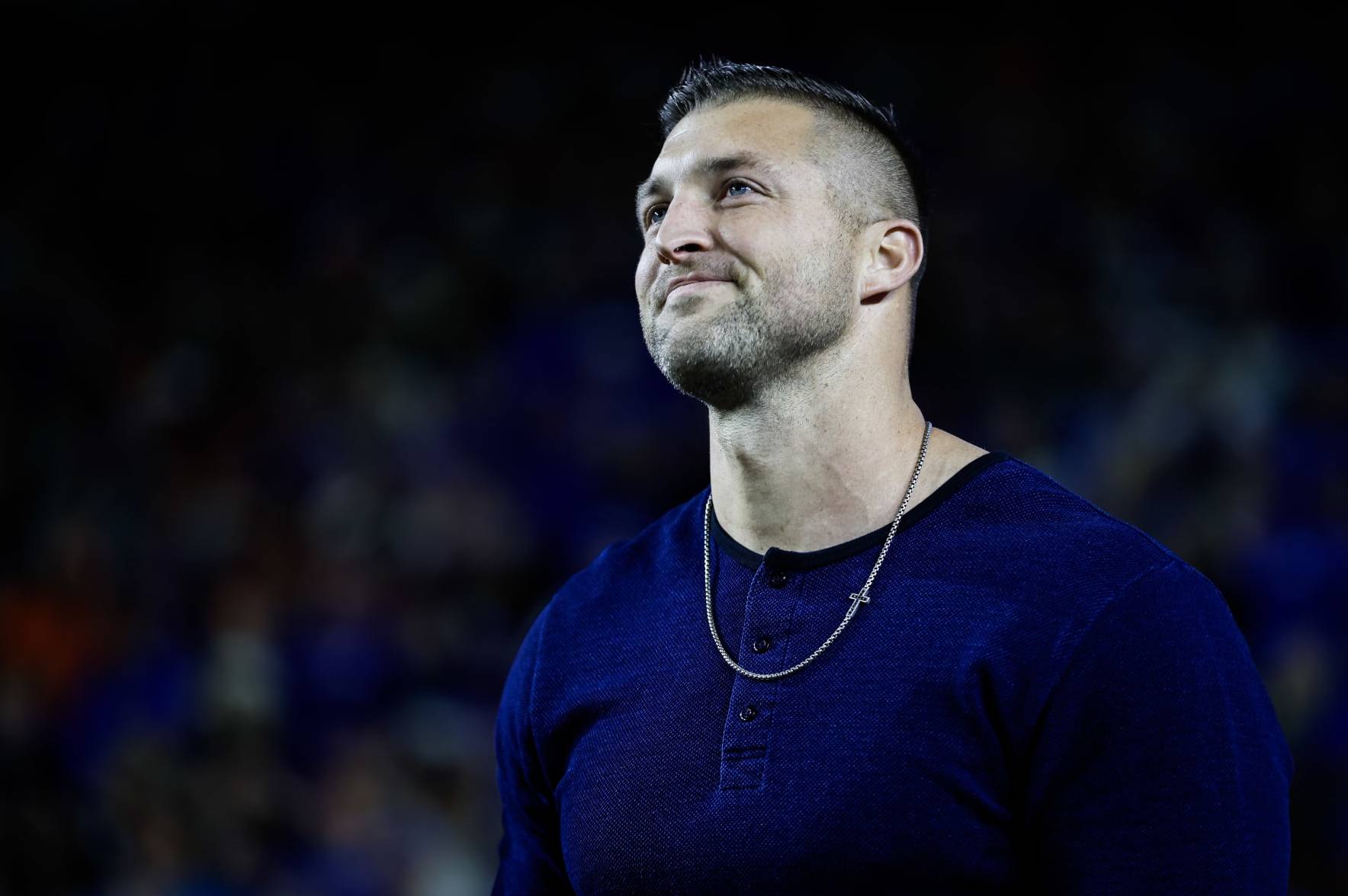 GAINESVILLE, FLORIDA - NOVEMBER 25: Former Florida Gators Quarterback and Heisman Trophy winner Tim Tebow reacts as he is honored after being inducted into the College Football Hall of Fame Class of 2023 during the first half of a game between the Florida Gators and the Florida State Seminoles at Ben Hill Griffin Stadium on November 25, 2023 in Gainesville, Florida. (Photo by James Gilbert/Getty Images)