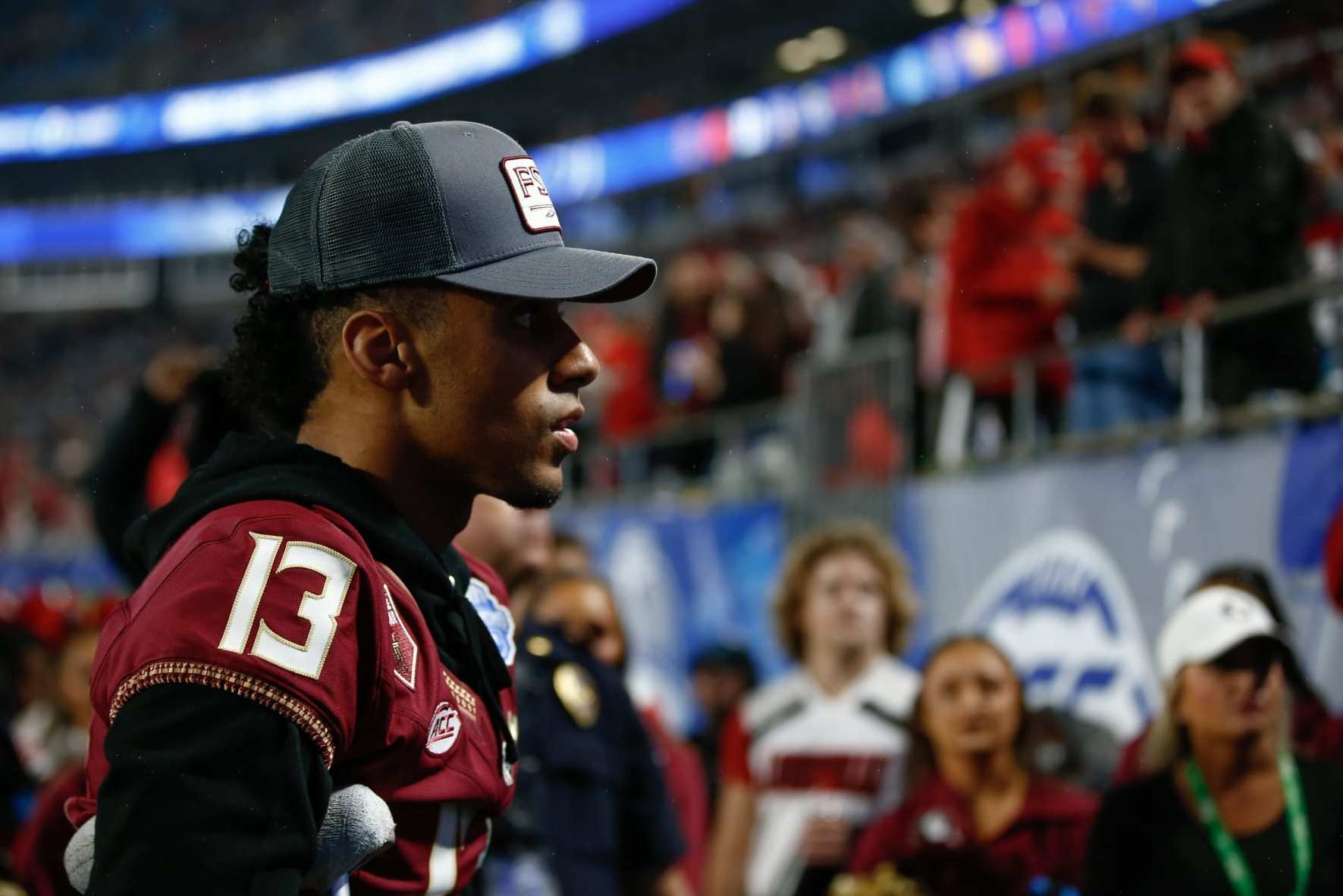 CHARLOTTE, NORTH CAROLINA - DECEMBER 2: Jordan Travis #13 of the Florida State Seminoles walks off the field after the first half against the Louisville Cardinals during the ACC Championship at Bank of America Stadium on December 2, 2023 in Charlotte, North Carolina. (Photo by Isaiah Vazquez/Getty Images)