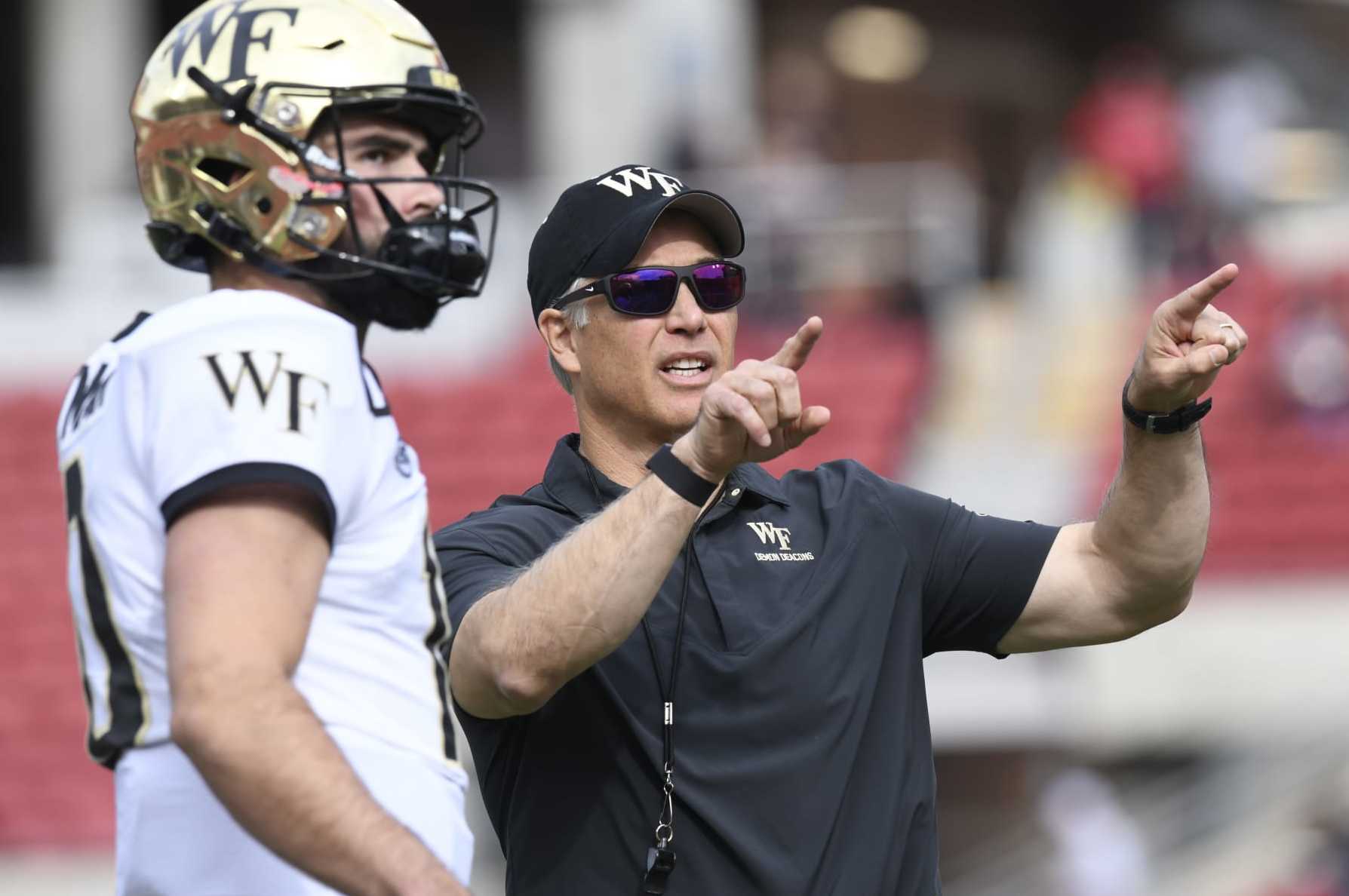 LOUISVILLE, KY - OCTOBER 29: Wake Forest Demon Deacons head coach Dave Clawson talks with Wake Forest Demon Deacons quarterback Sam Hartman (10) before the college football game between the Wake Forest Demon Deacons and the Louisville Cardinals on October 29, 2022, at Cardinal Stadium in Louisville, Kentucky. (Photo by Michael Allio/Icon Sportswire via Getty Images)