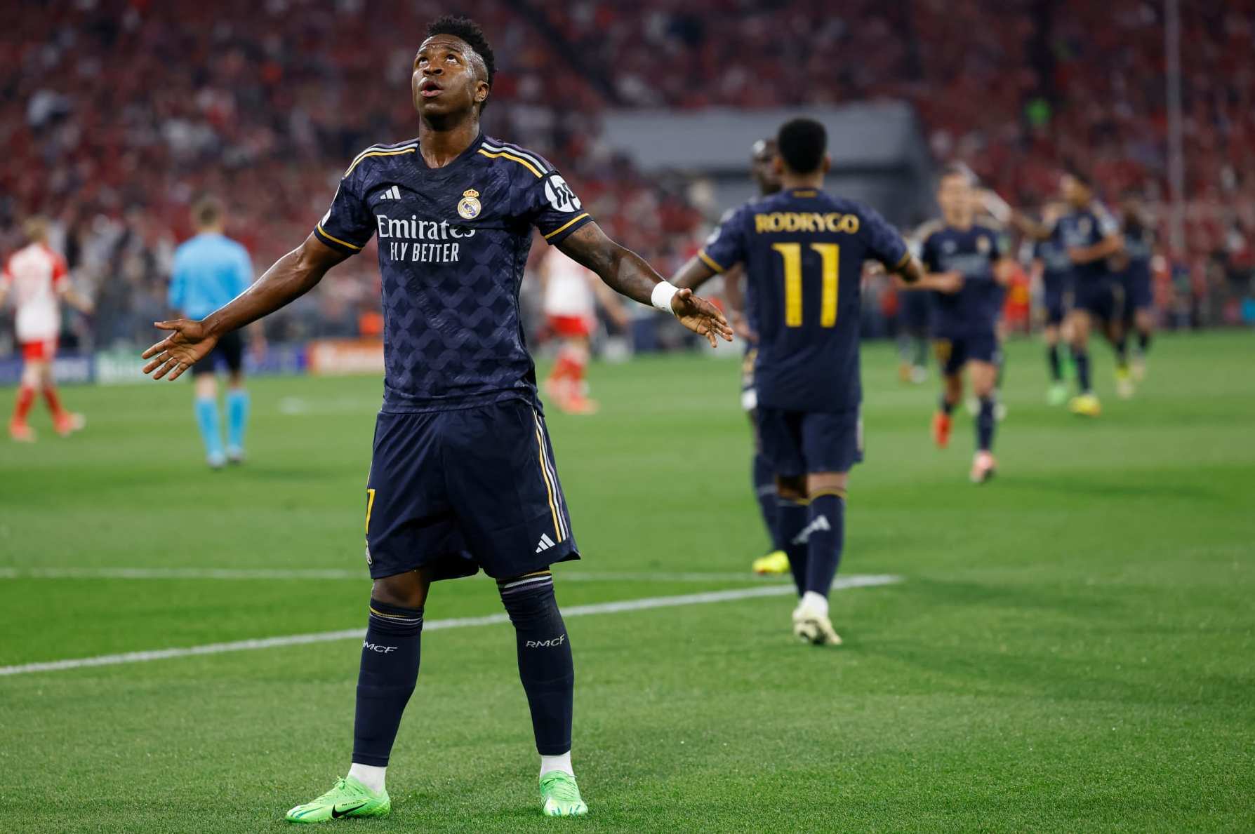 Real Madrid's Brazilian forward #07 Vinicius Junior celebrates scoring the opening goal with his teammates during the UEFA Champions League semi-final first leg football match between FC Bayern Munich and Real Madrid CF on April 30, 2024 in Munich, southern Germany. (Photo by Michaela STACHE / AFP) (Photo by MICHAELA STACHE/AFP via Getty Images)