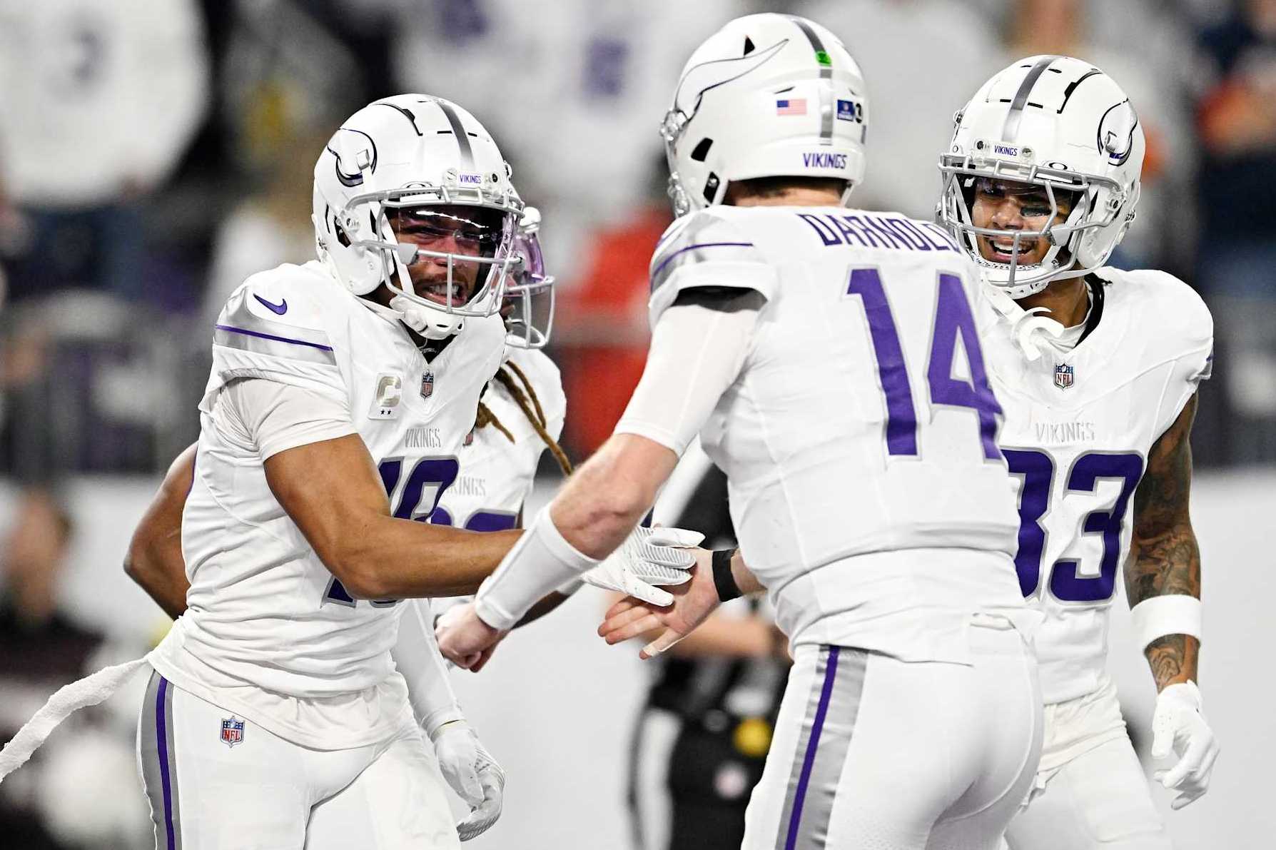 MINNEAPOLIS, MINNESOTA - DECEMBER 16: Justin Jefferson #18 celebrates with Sam Darnold #14 of the Minnesota Vikings after a touchdown during the first quarter against the Chicago Bears at U.S. Bank Stadium on December 16, 2024 in Minneapolis, Minnesota. (Photo by Stephen Maturen/Getty Images)