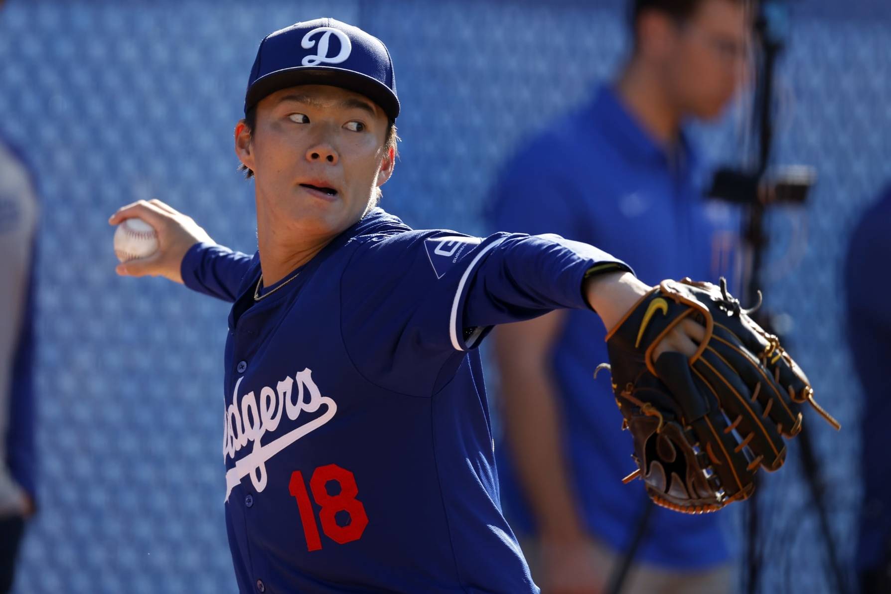 GLENDALE, ARIZONA - FEBRUARY 14: Yoshinobu Yamamoto #18 of the Los Angeles Dodgers pitches during workouts at Camelback Ranch on February 14, 2024 in Glendale, Arizona. (Photo by Chris Coduto/Getty Images)