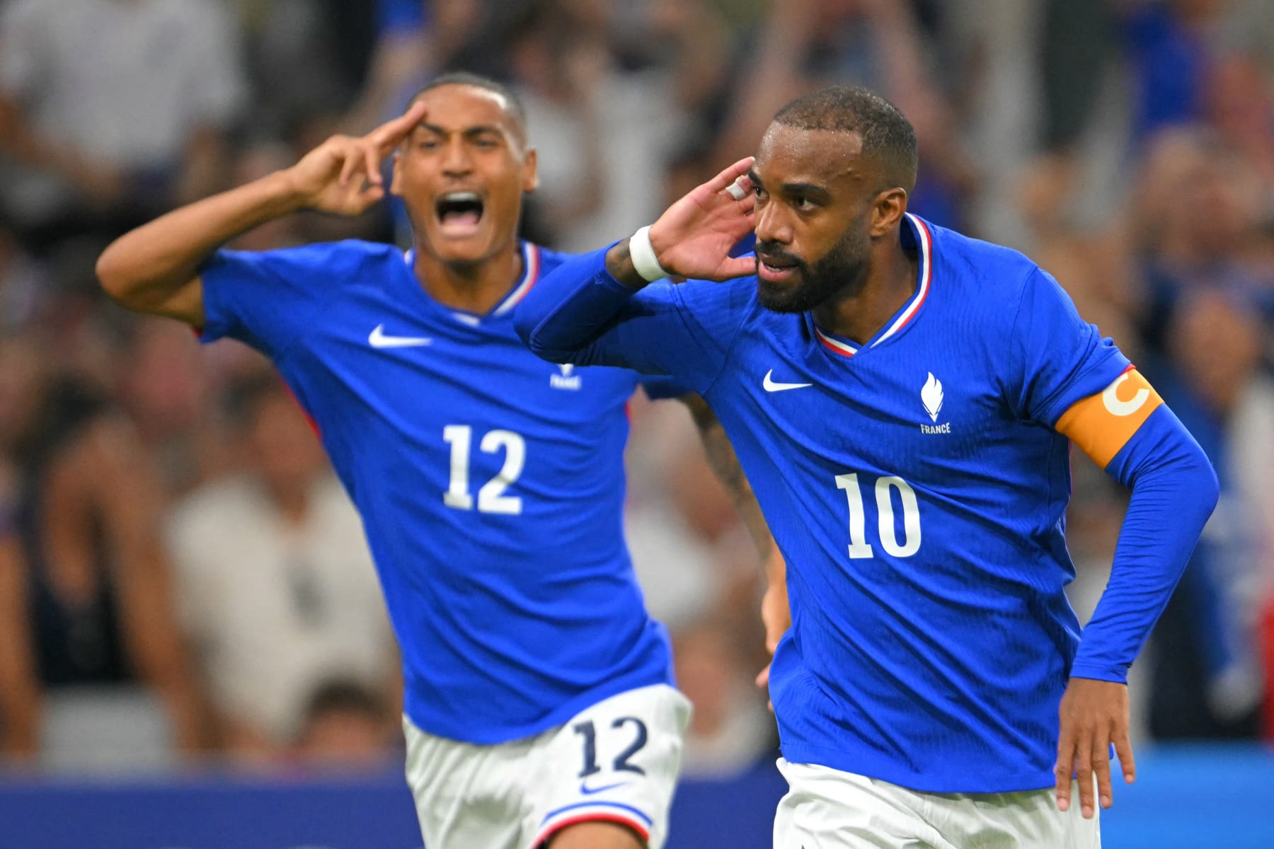 TOPSHOT - France's forward #10 Alexandre Lacazette (R) celebrates after scoring a goal during the men's group A football match between France and the USA as part of the Paris 2024 Olympic Games at the Marseille Stadium in Marseille on July 24, 2024. (Photo by NICOLAS TUCAT / AFP) (Photo by NICOLAS TUCAT/AFP via Getty Images)