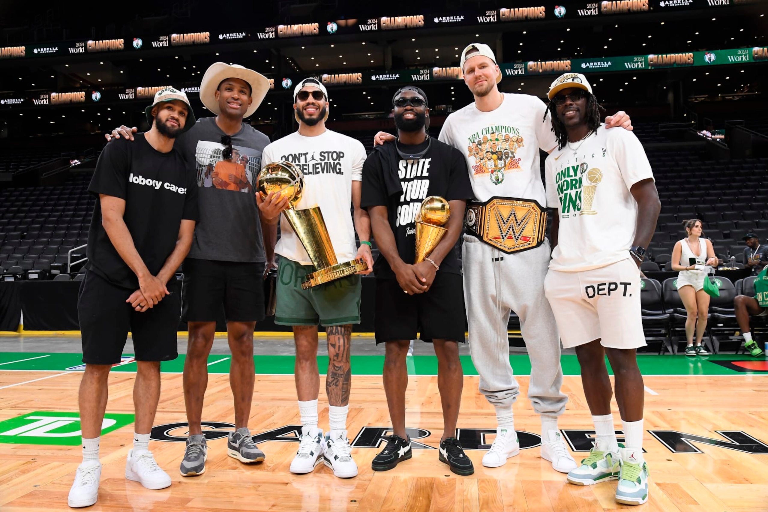 BOSTON, MA - JUNE 21: Derrick White #9, Al Horford #42, Jayson Tatum #0, Jaylen Brown #7, Kristaps Porzingis #8, and Jrue Holiday #4 of the Boston Celtics pose for a photo with the Larry O'Brien Trophy and the Bill Russell Finals MVP Trophy before the 2024 Boston Celtics championship parade on June 21, 2024 in Boston, Massachusetts. NOTE TO USER: User expressly acknowledges and agrees that, by downloading and or using this photograph, User is consenting to the terms and conditions of the Getty Images License Agreement. Mandatory Copyright Notice: Copyright 2024 NBAE (Photo by Brian Babineau/NBAE via Getty Images)