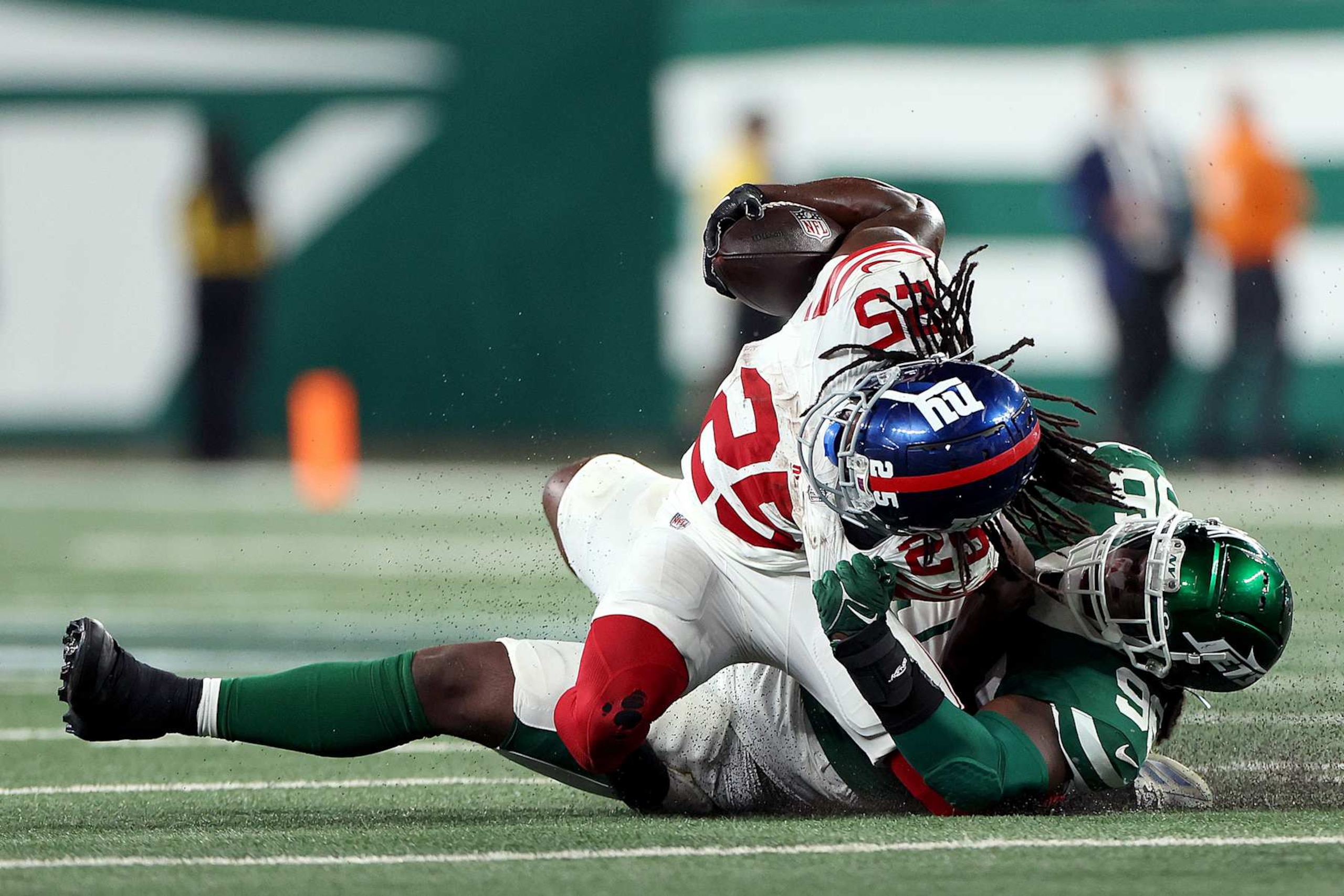 EAST RUTHERFORD, NEW JERSEY - AUGUST 24: Dante Miller #25 of the New York Giants is tackled by Leonard Taylor III #96 of the New York Jets during the second quarter of a preseason game at MetLife Stadium on August 24, 2024 in East Rutherford, New Jersey. (Photo by Luke Hales/Getty Images) EAST RUTHERFORD, NEW JERSEY - AUGUST 24: Dante Miller #25 of the New York Giants is tackled by Leonard Taylor III #96 of the New York Jets during the second quarter of a preseason game at MetLife Stadium on August 24, 2024 in East Rutherford, New Jersey. (Photo by Luke Hales/Getty Images)