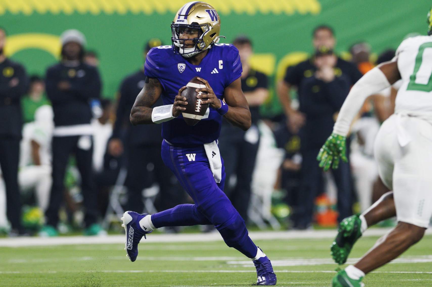 LAS VEGAS, NEVADA - DECEMBER 1: Michael Penix Jr. #9 of the Washington Huskies rolls out to pass against the Oregon Ducks during the Pac-12 Championship at Allegiant Stadium on December 1, 2023 in Las Vegas, Nevada. (Photo by Ric Tapia/Getty Images)