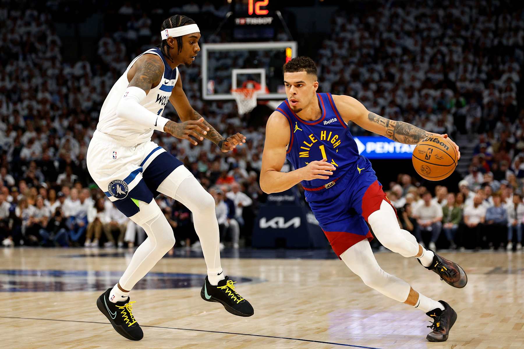 MINNEAPOLIS, MINNESOTA - MAY 10: Michael Porter Jr. #1 of the Denver Nuggets drives to the basket against Jaden McDaniels #3 of the Minnesota Timberwolves in the first quarter of Game Three of the Western Conference Second Round Playoffs at Target Center on May 10, 2024 in Minneapolis, Minnesota. The Nuggets defeated the Timberwolves 117-90. (Photo by David Berding/Getty Images)
