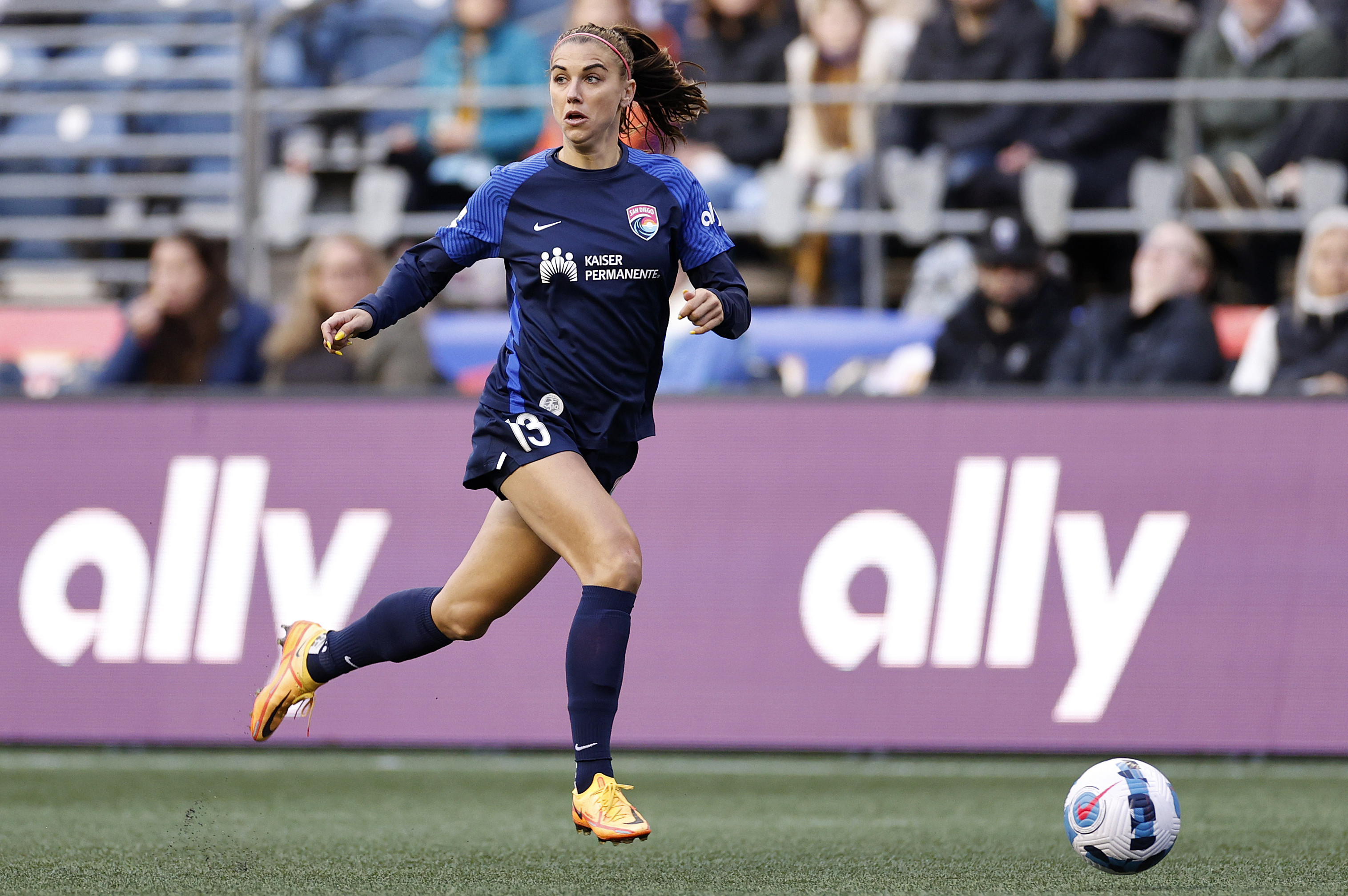 SEATTLE, WASHINGTON - APRIL 14: Alex Morgan #13 of San Diego Wave FC  controls the ball during the first half against the OL Reign at Lumen Field on April 14, 2022 in Seattle, Washington. (Photo by Steph Chambers/Getty Images)